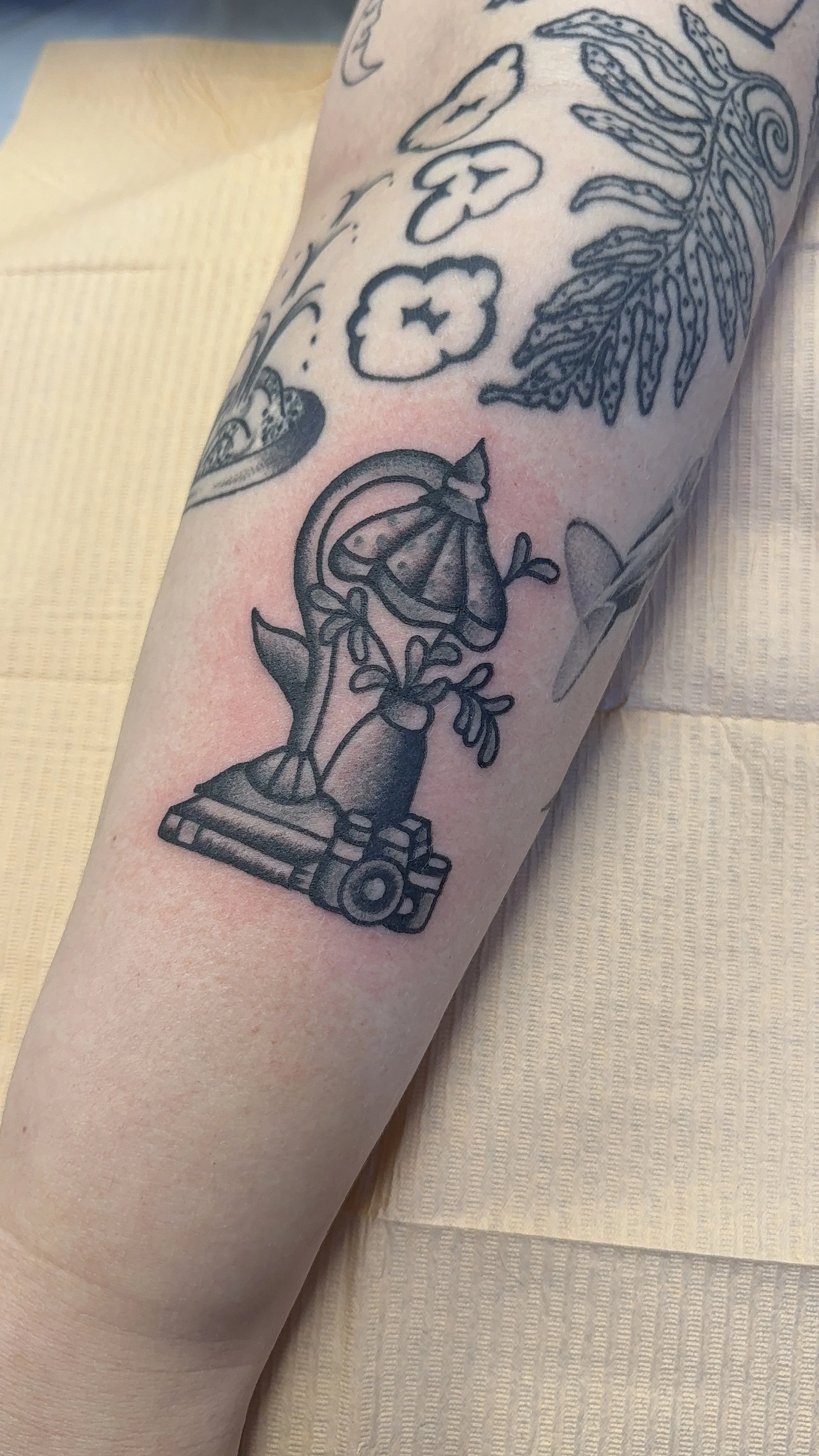 American Traditional Tattoo made in Portland, Oregon flash tattoo of lamp and camera black and grey tattoo