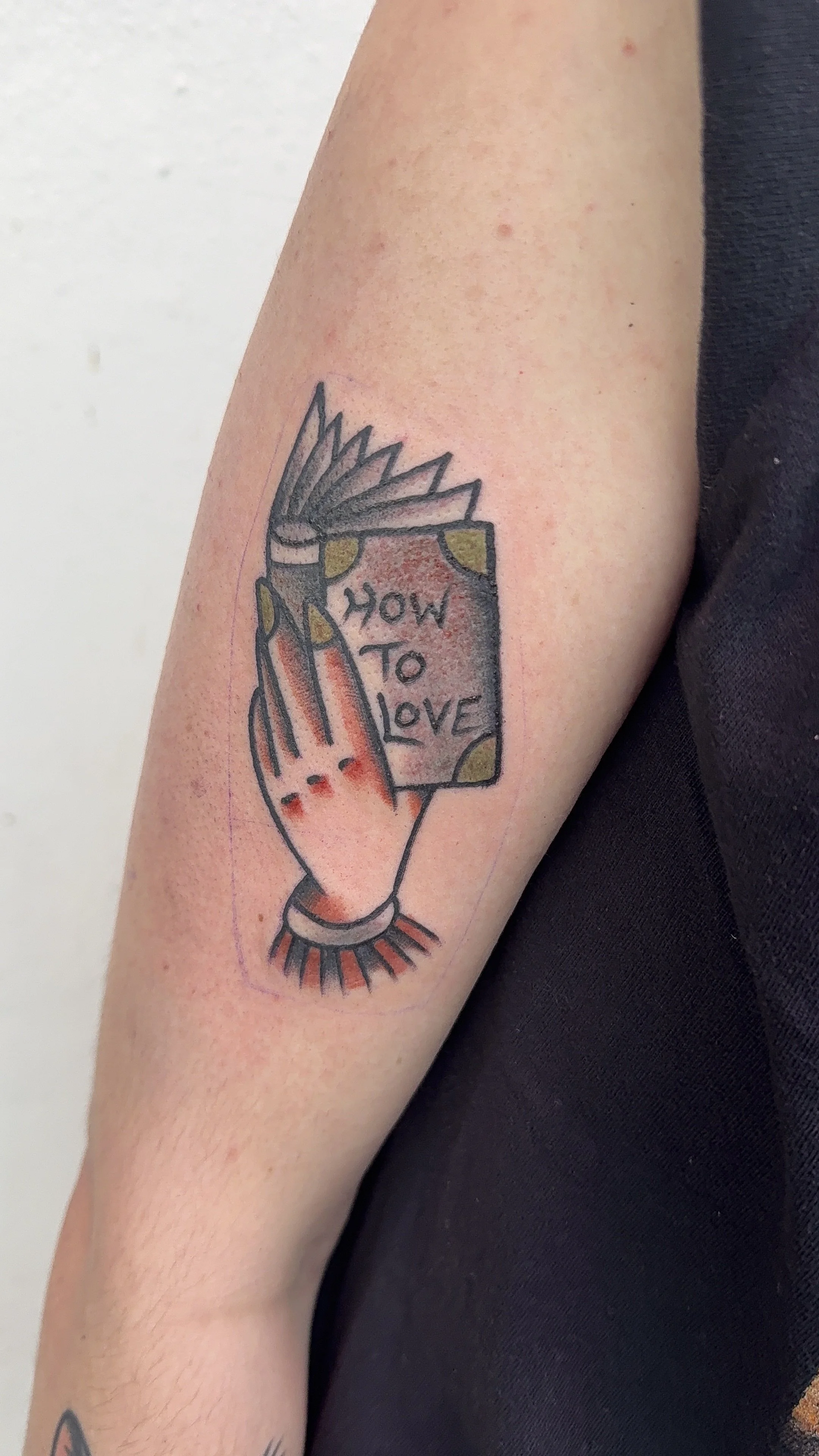 valentines day tattoo hand holding book tattoo american traditional style