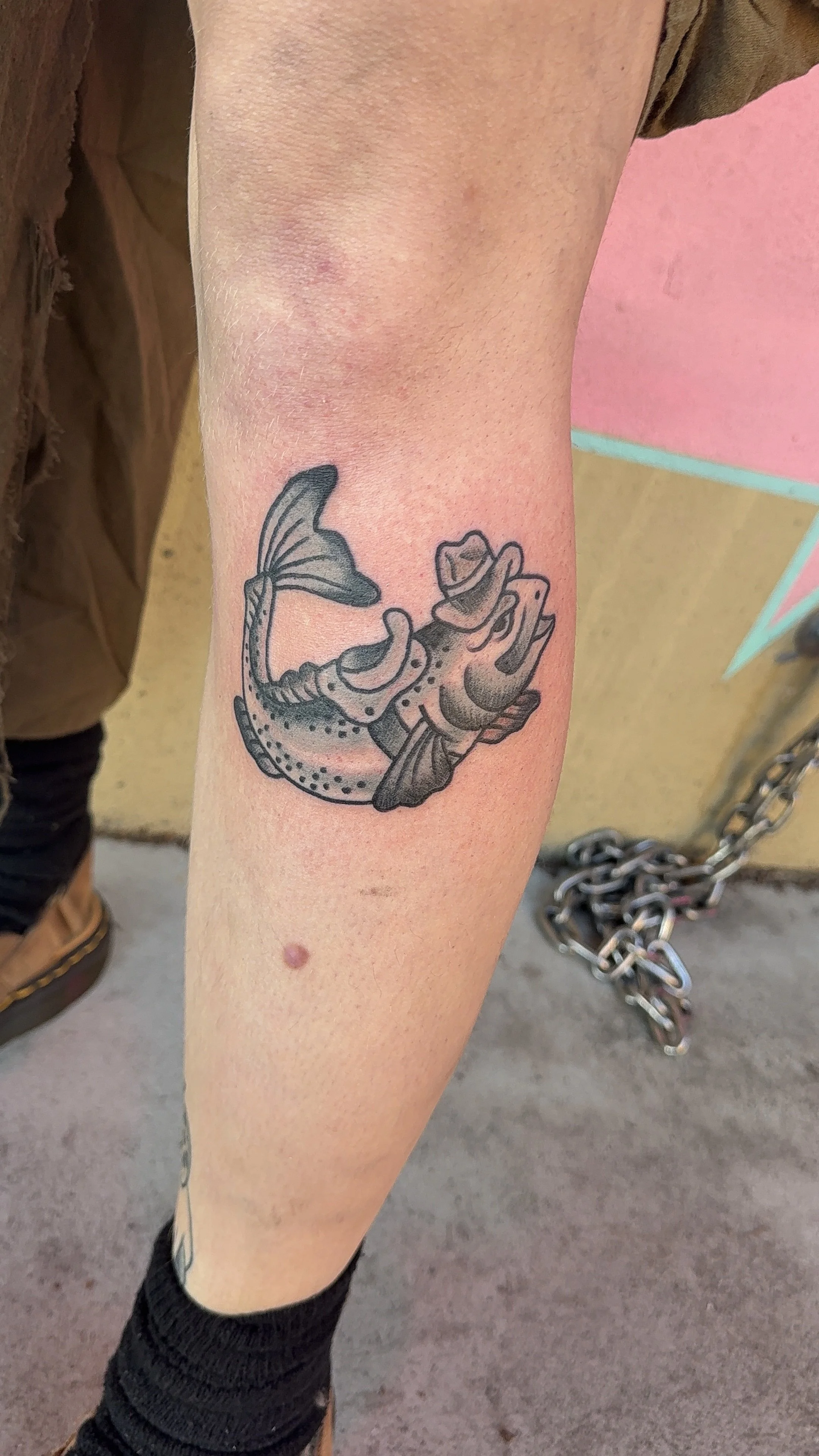 american traditional style black and grey cowboy fish tattoo