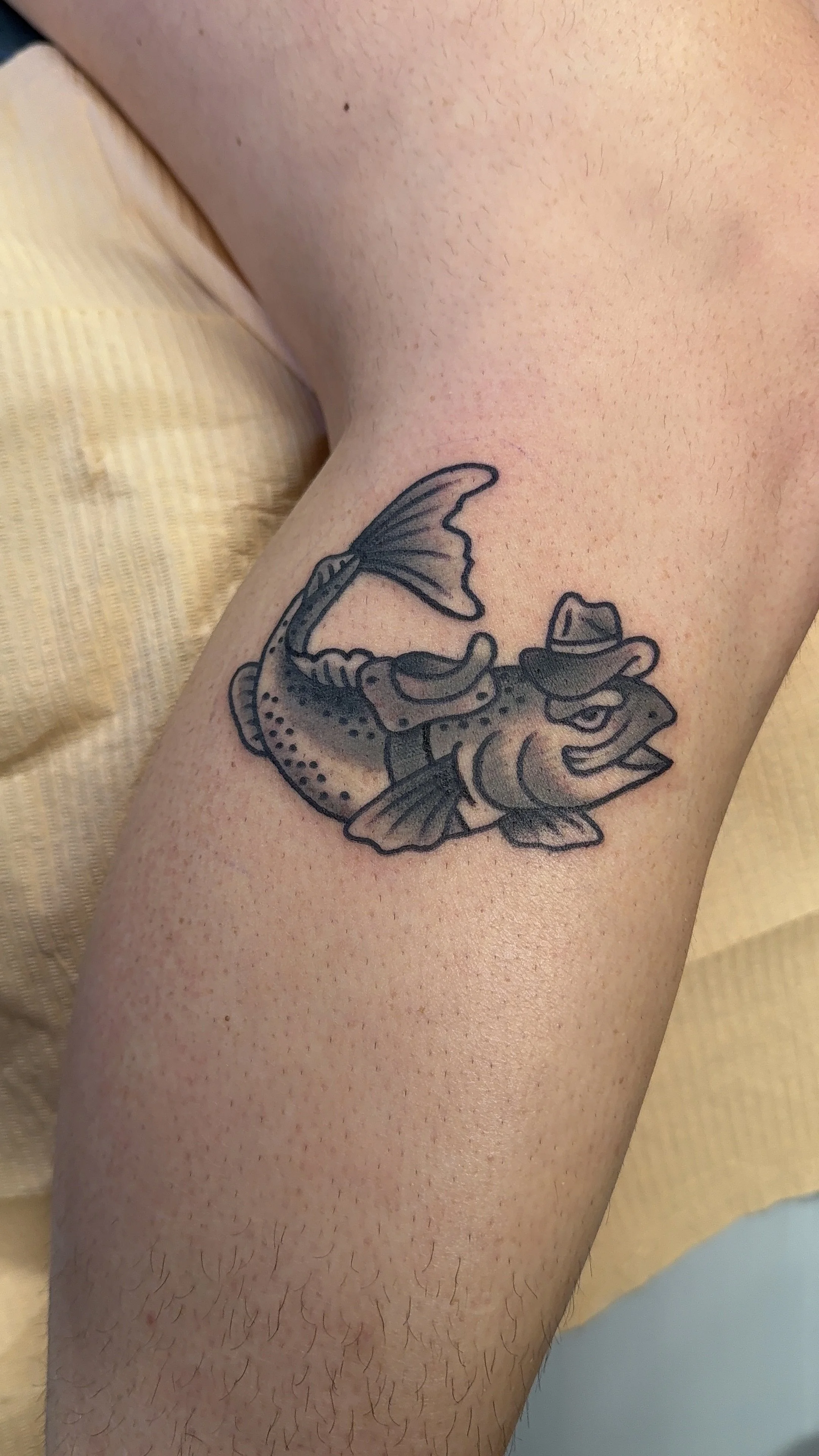 american traditional style black and grey fish cowboy tattoo