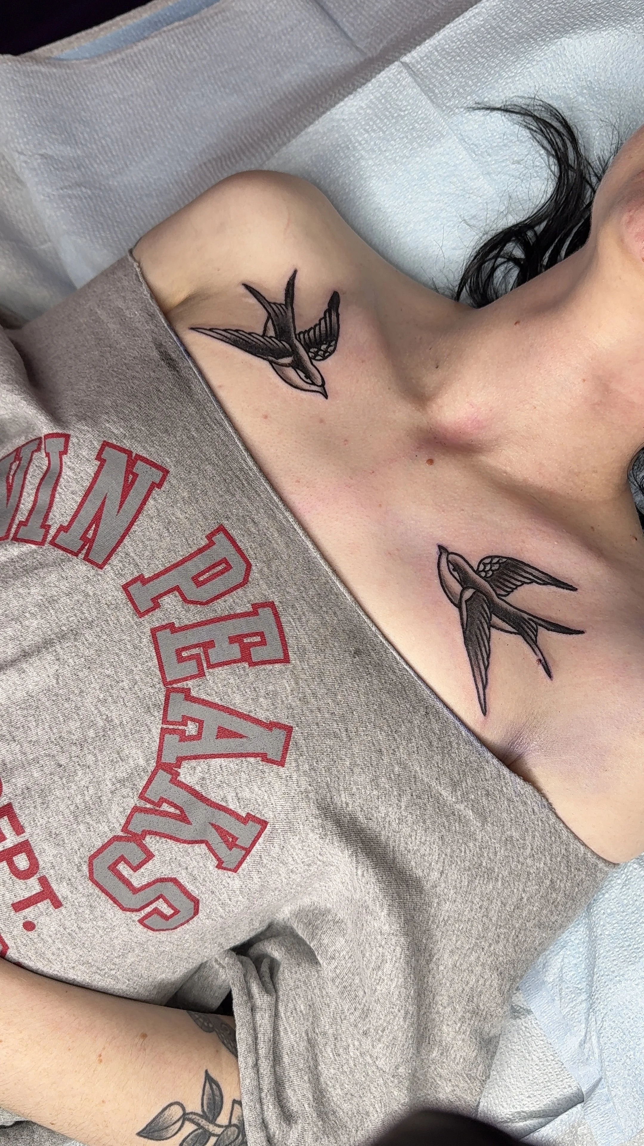 Two American traditional collarbone tattoos in black and grey 