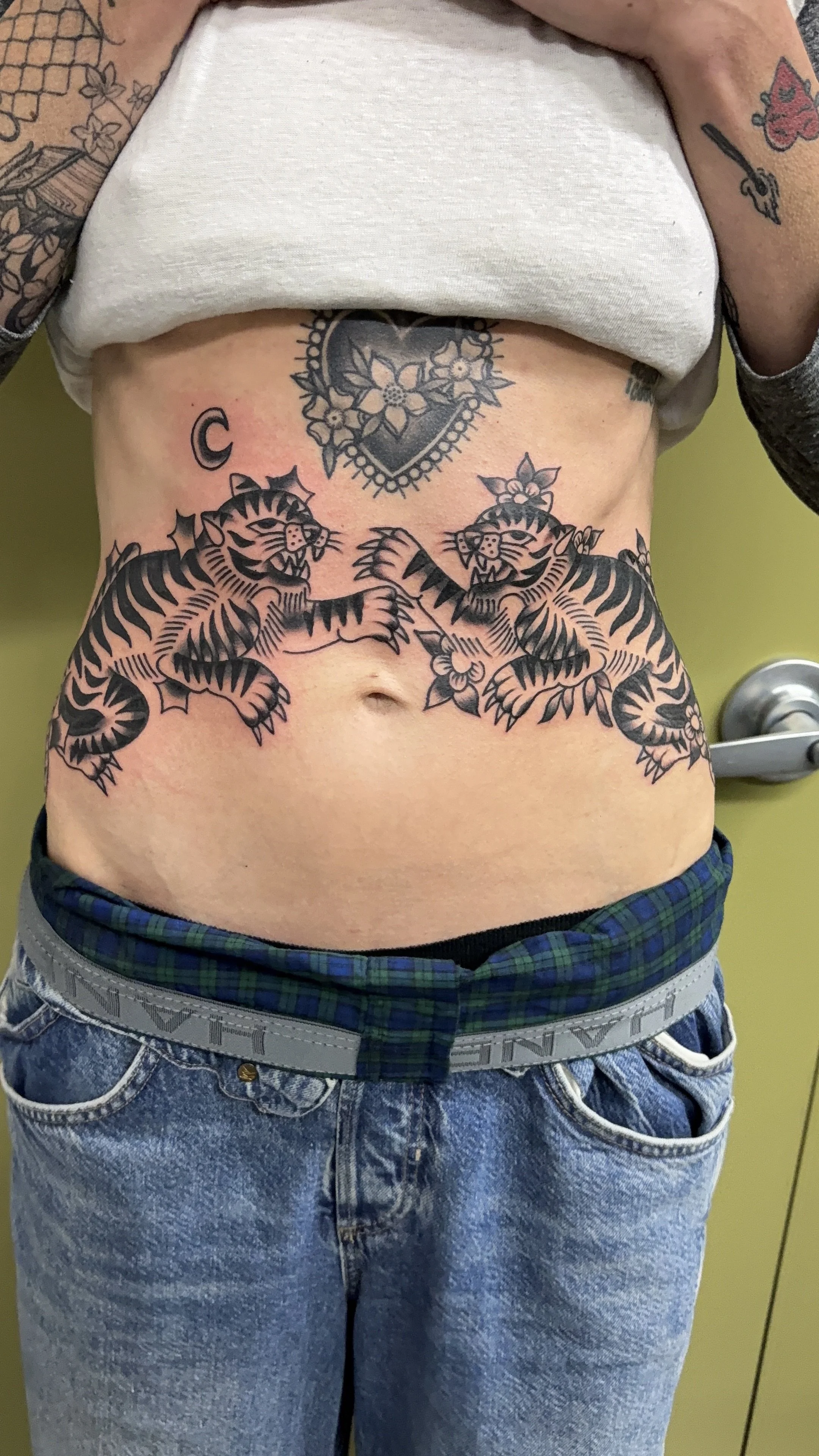 american traditional style blackwork tigers tattoo on stomach