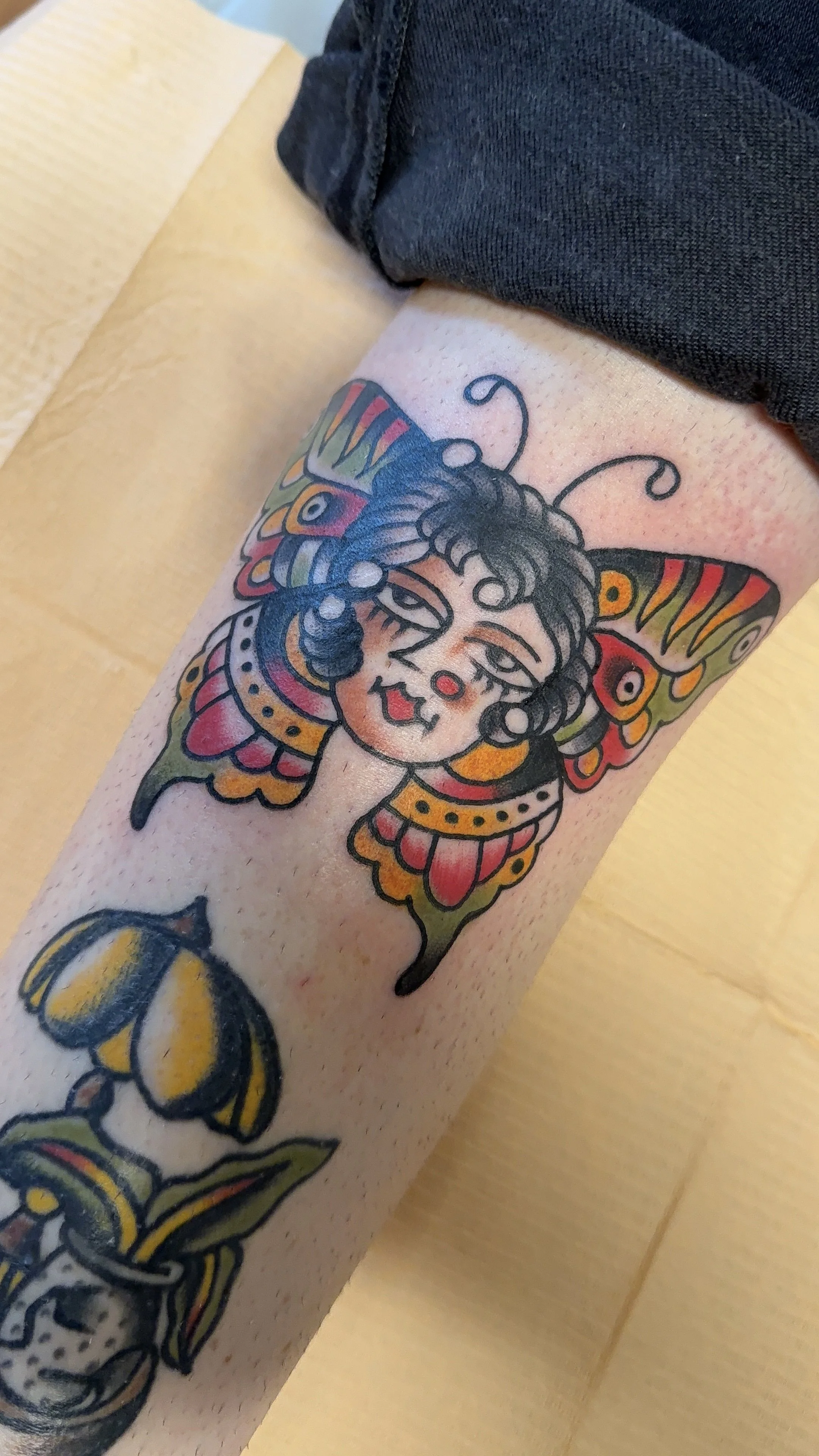 american traditional style butterfly girl tattoo