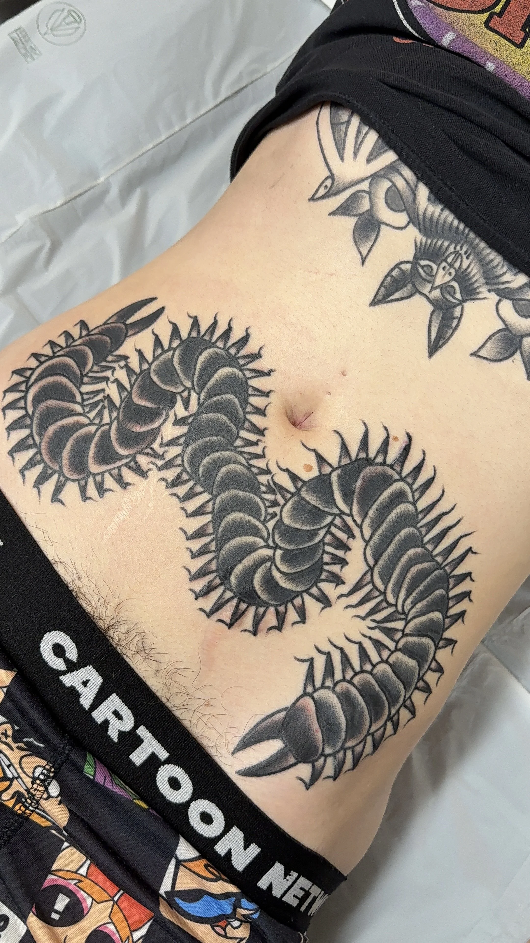 american traditional style centipede stomach tattoo