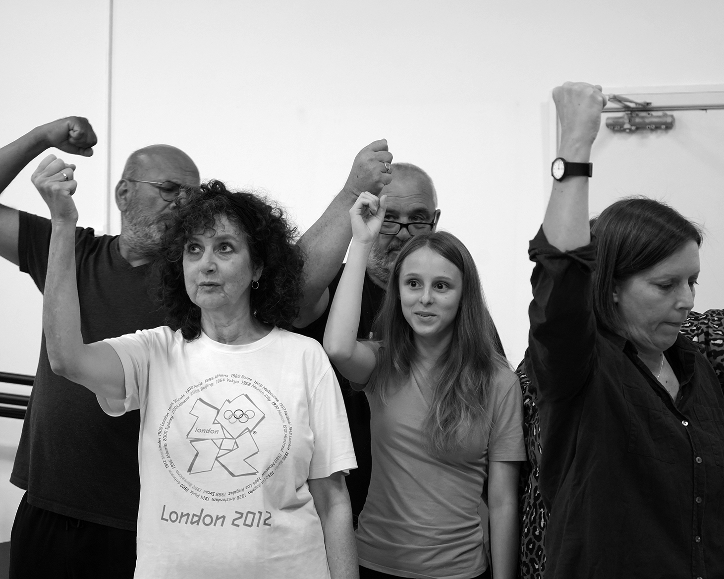 Group of people raising fists in a black and white photo