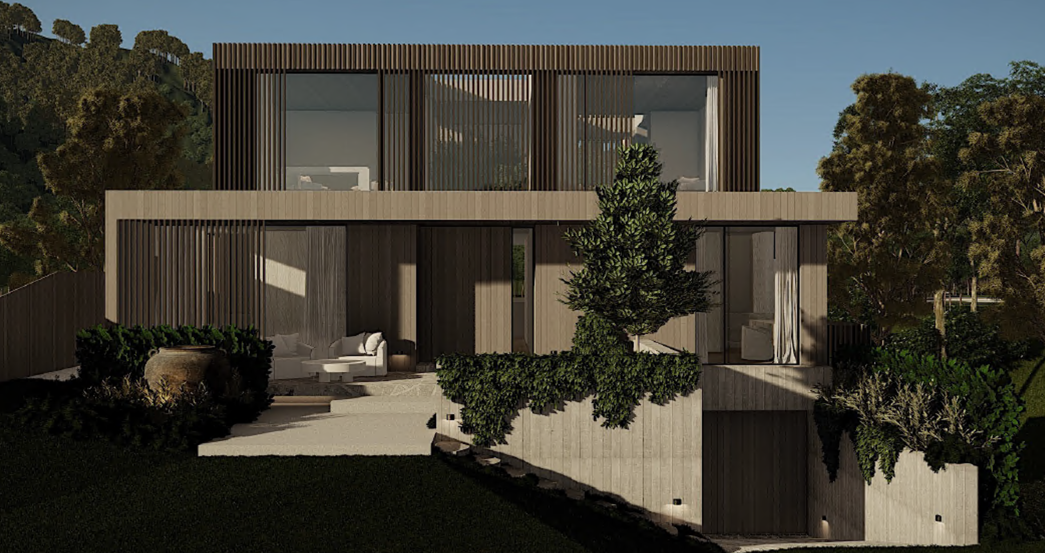 Modern multi-story house with wooden exterior, large glass windows, outdoor seating, surrounded by trees and greenery.