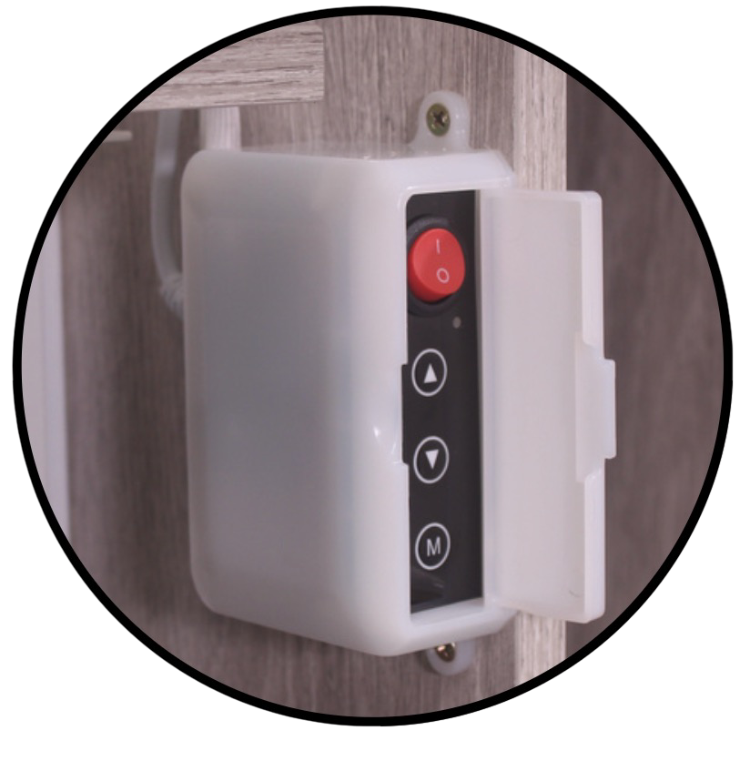 A wall-mounted control device with a red power switch at the top, black and white buttons below with arrows and an M button, and an open cover revealing internal components.