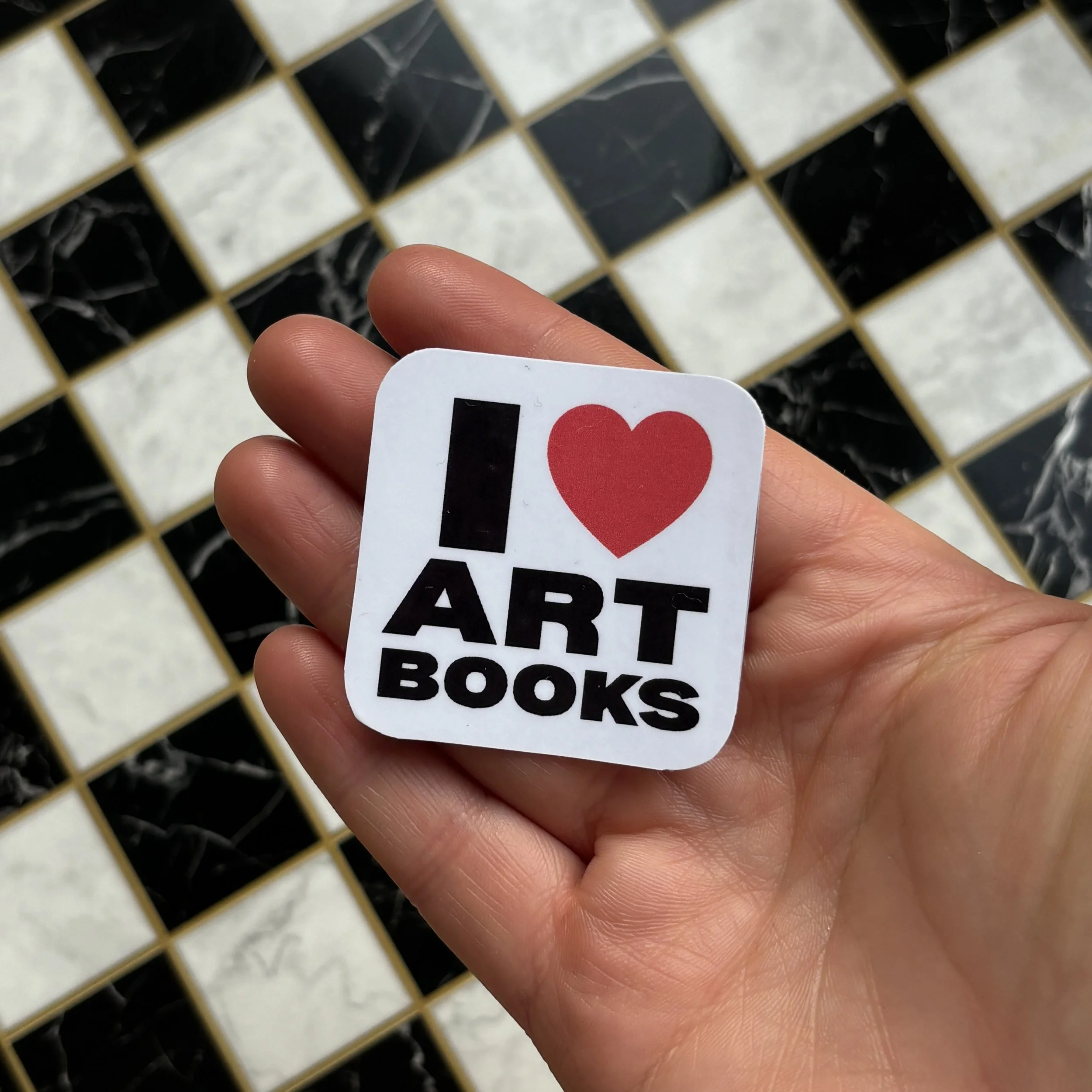 i love art books sticker holding over checkerboard.jpg