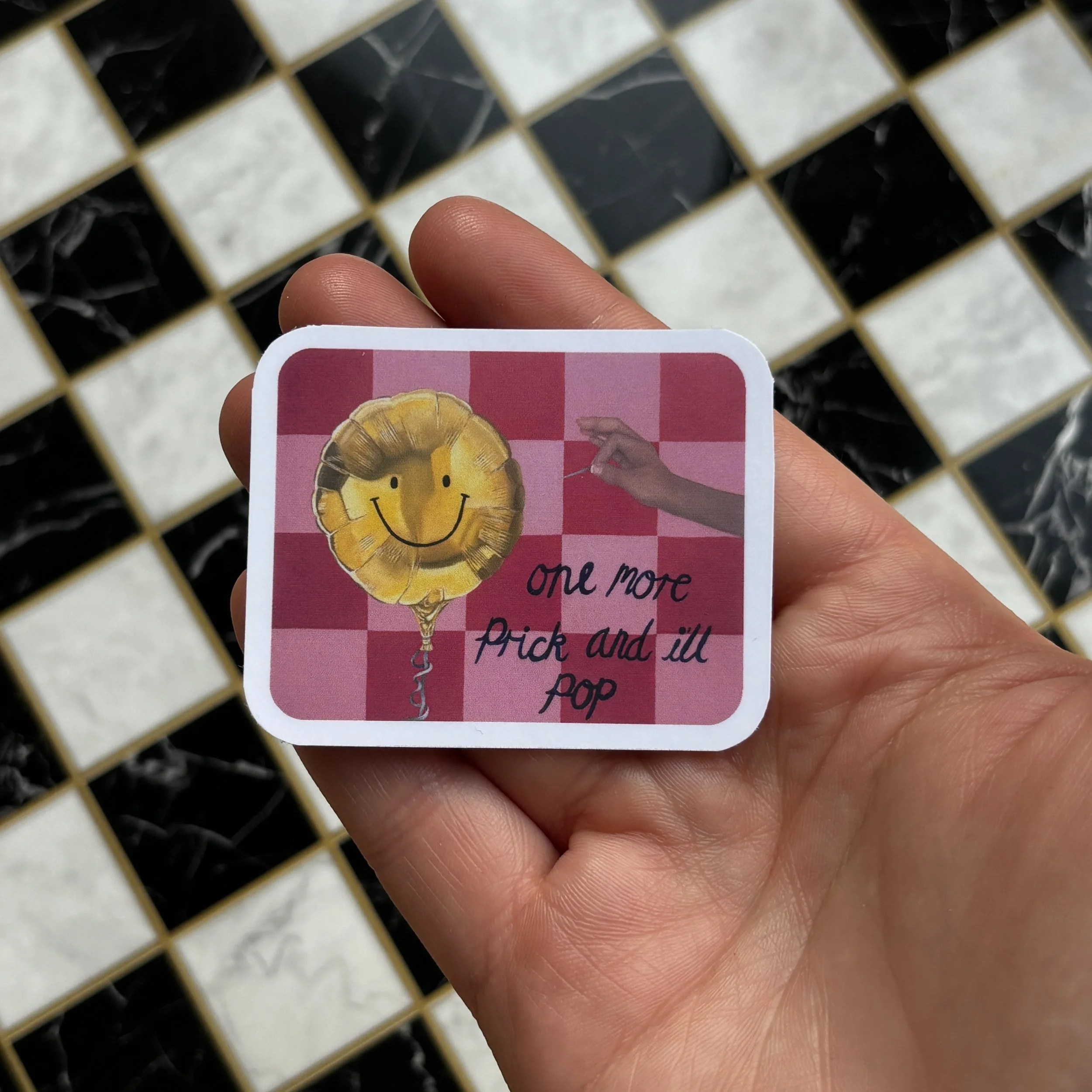 everything is fine sticker holding over checkerboard.jpg