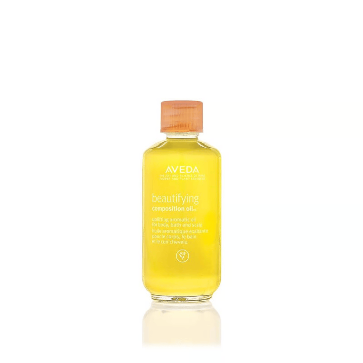 Clear bottle of golden Aveda Beautifying Composition Oil, multi-use aromatic blend for body, bath and scalp.