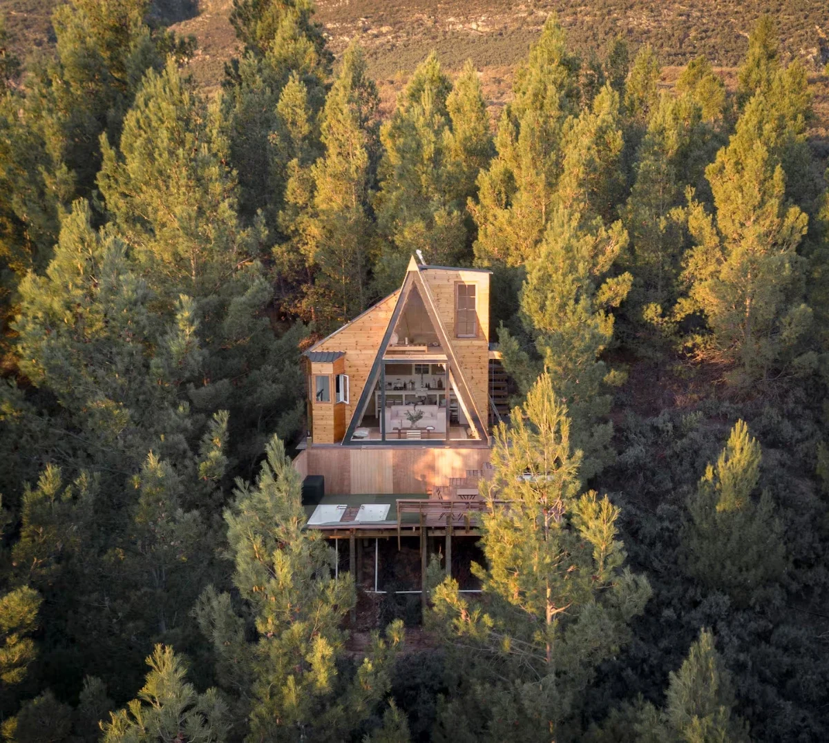 Contemporary eco home at La Bruyere Farm with landscaped garden and mountain backdrop in Cape countryside.
