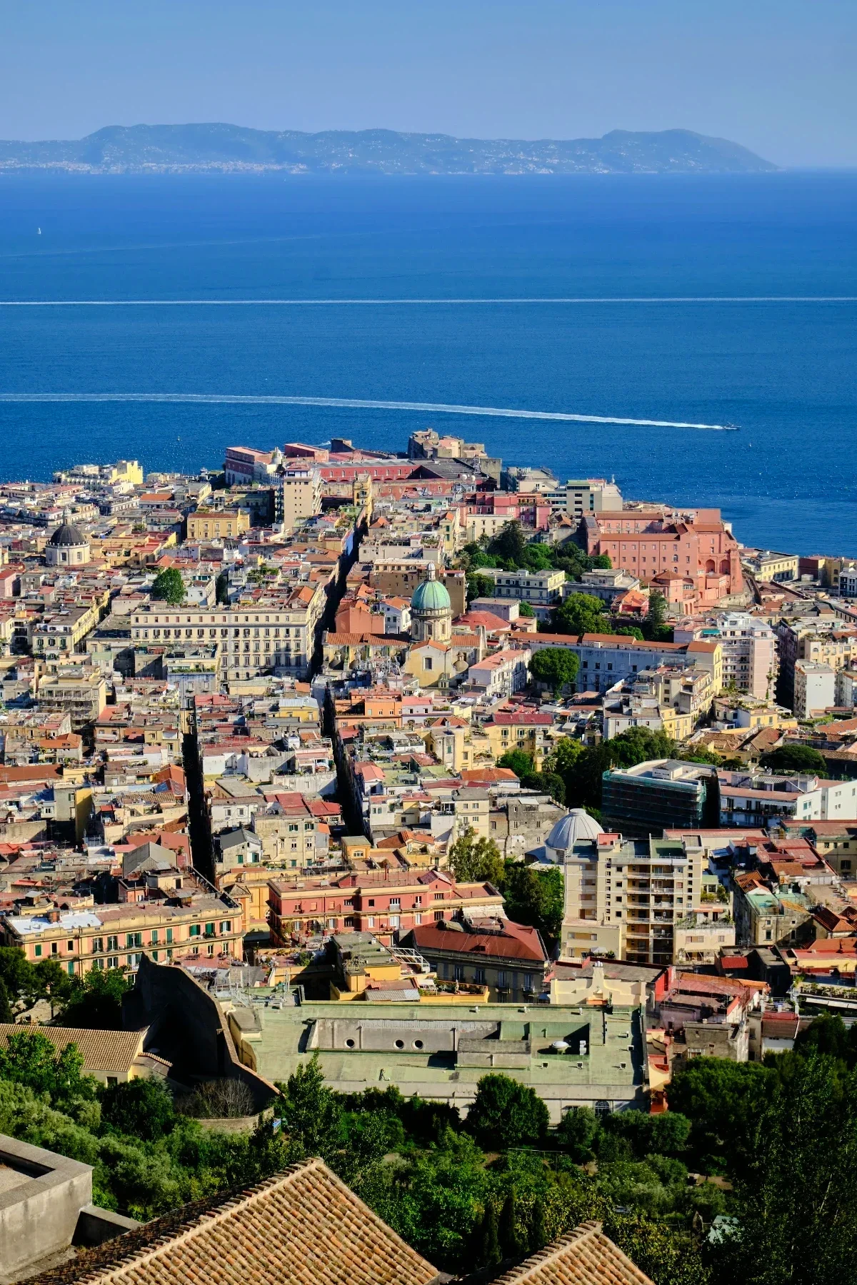  Panoramic aerial of Naples stretching to the Tyrrhenian Sea with Capri on the horizon. 