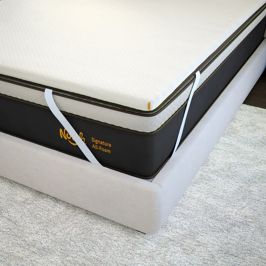  Nolah Signature foam topper secured with corner straps on an all-foam mattress. 