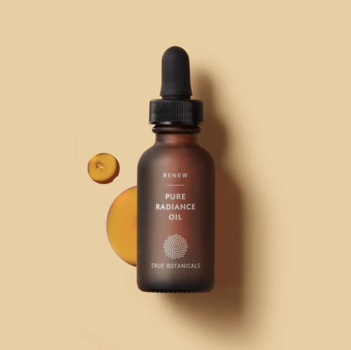 Amber dropper bottle of True Botanicals Pure Radiance Oil.