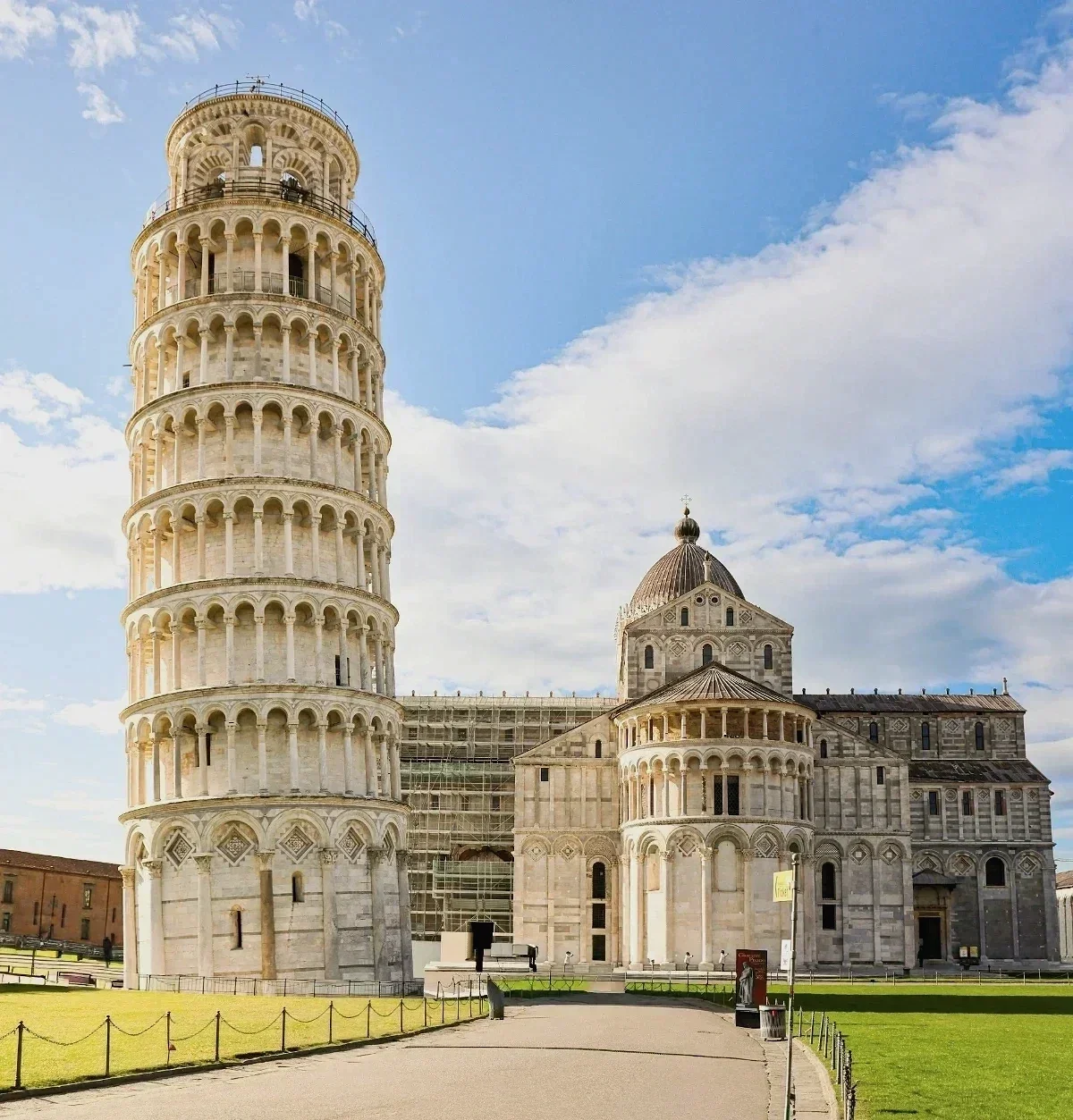  Leaning Tower of Pisa and Pisa Cathedral shining under a bright blue sky in late afternoon. 