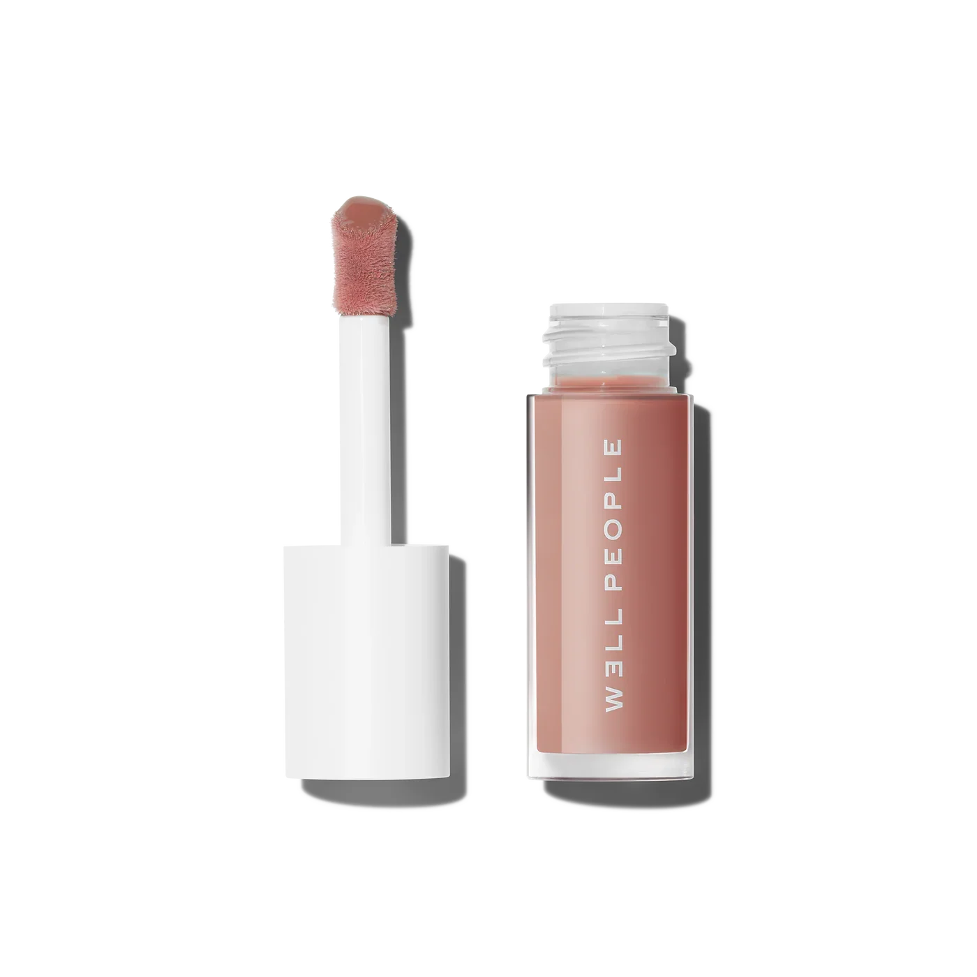 Well People Lush Lip Tinted Lip Oil in soft nude; open tube with doe-foot applicator shown next to clear bottle.