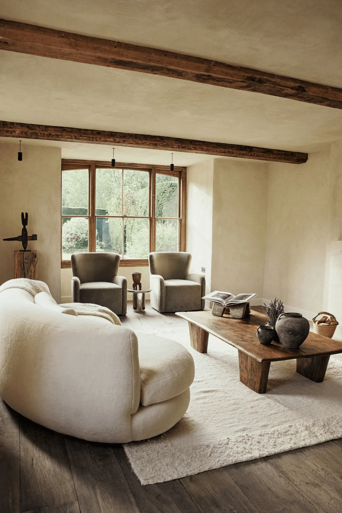 Warm, earth-toned living room with Khayni Rowen reclaimed oak coffee table.