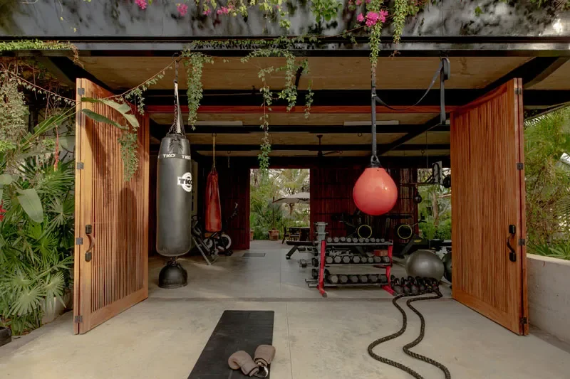  Open-air jungle gym with punching bags, free weights and hanging vines invites energizing workouts at Musa MX. 