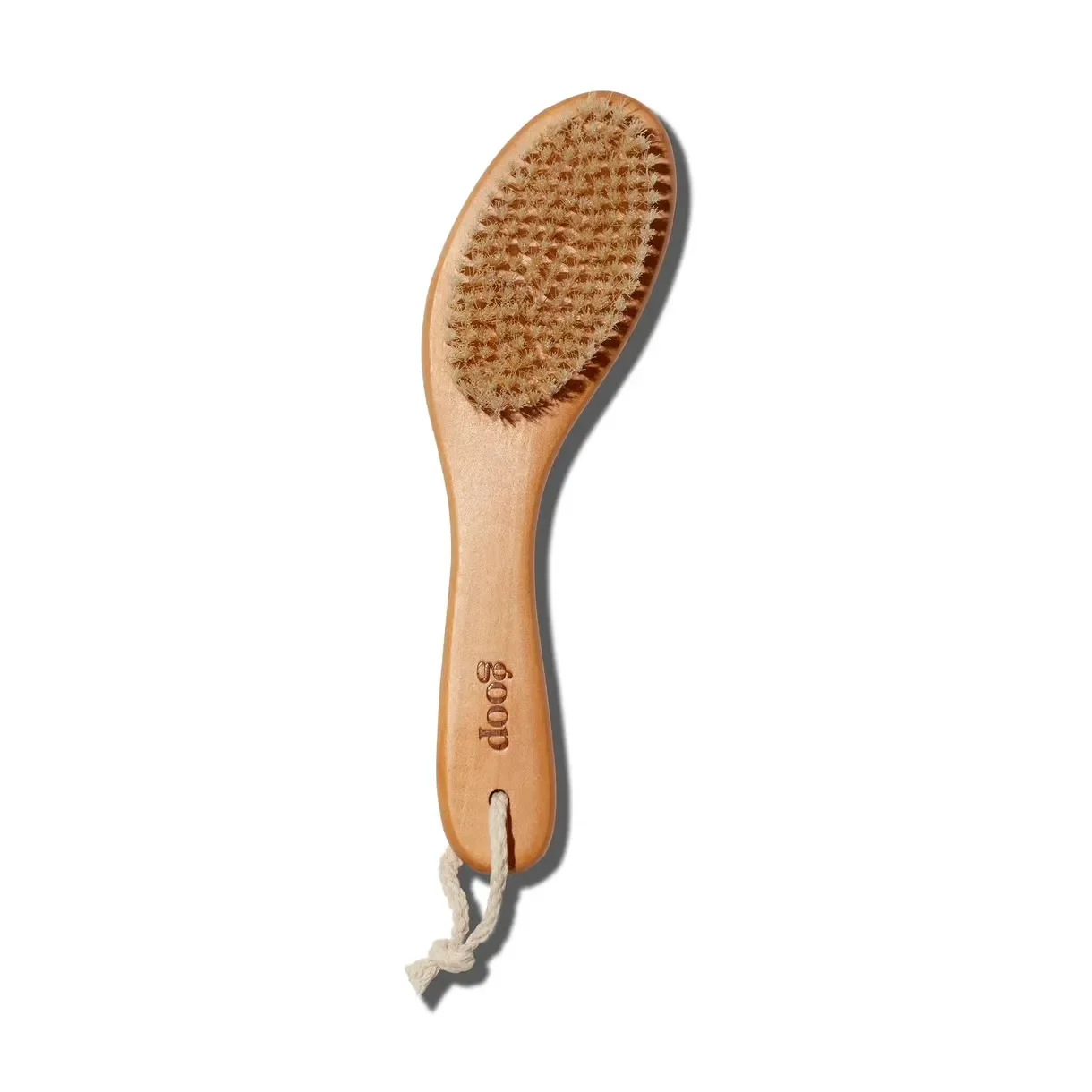 Goop wooden-handle facial dry brush with natural bristles.