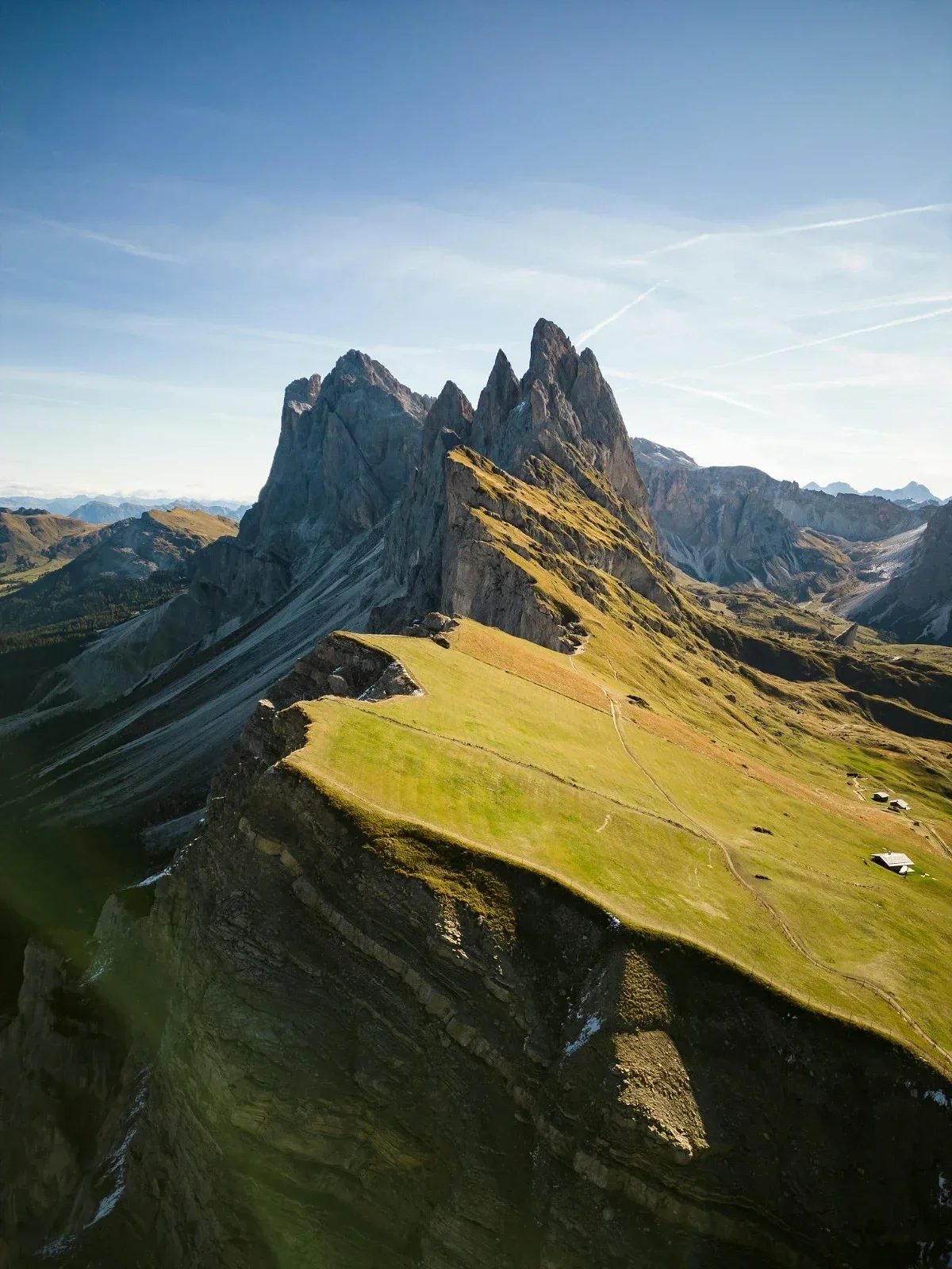  Seceda ridgeline in the Dolomites with dramatic jagged peaks and alpine hiking path. 