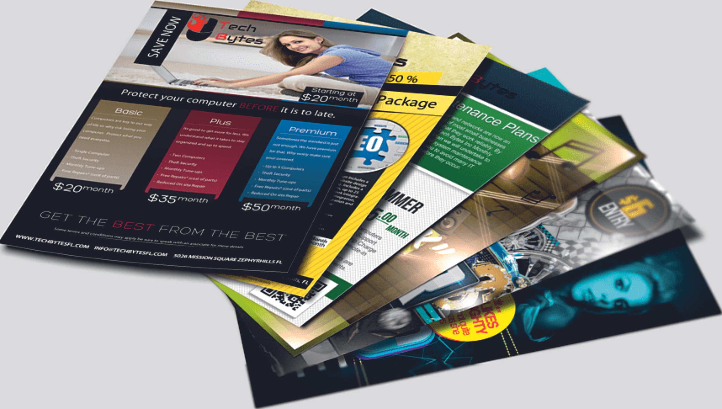 Stack of promotional flyers displaying computer services and maintenance plans with pricing details and contact information. Signmakers Cork & Kerry, Ireland.