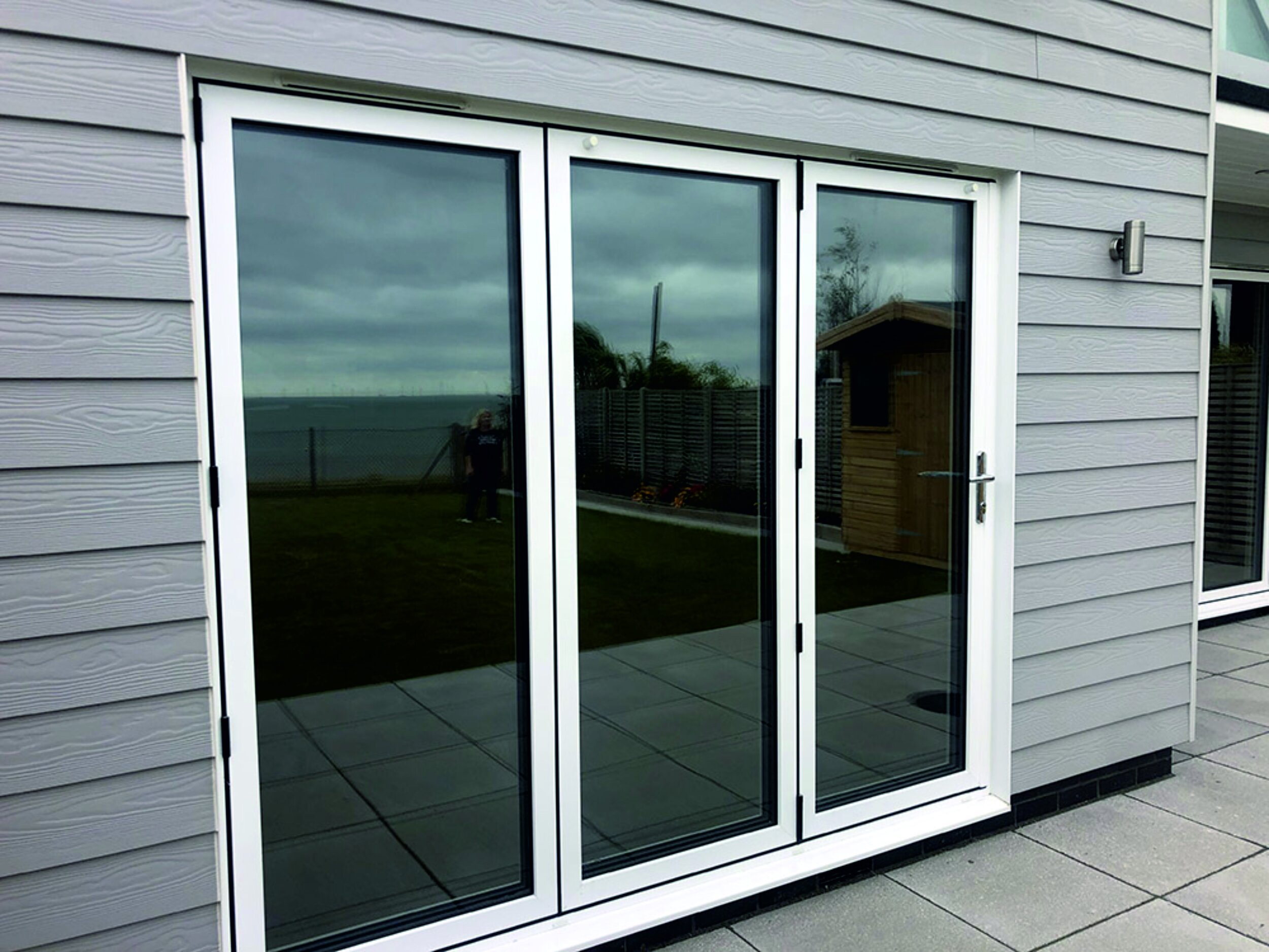 Modern wooden garden room with mirror glass vinyl film doors. Privacy film. Signmakers Cork & Kerry, Ireland.