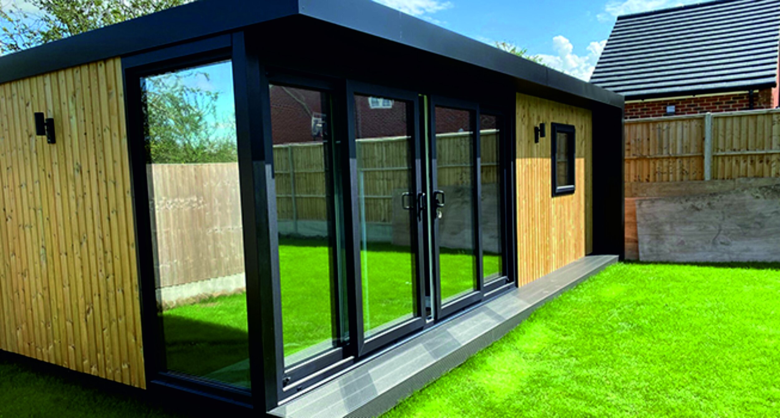 Modern wooden garden room with mirror glass vinyl film doors. Privacy film. Signmakers Cork & Kerry, Ireland.