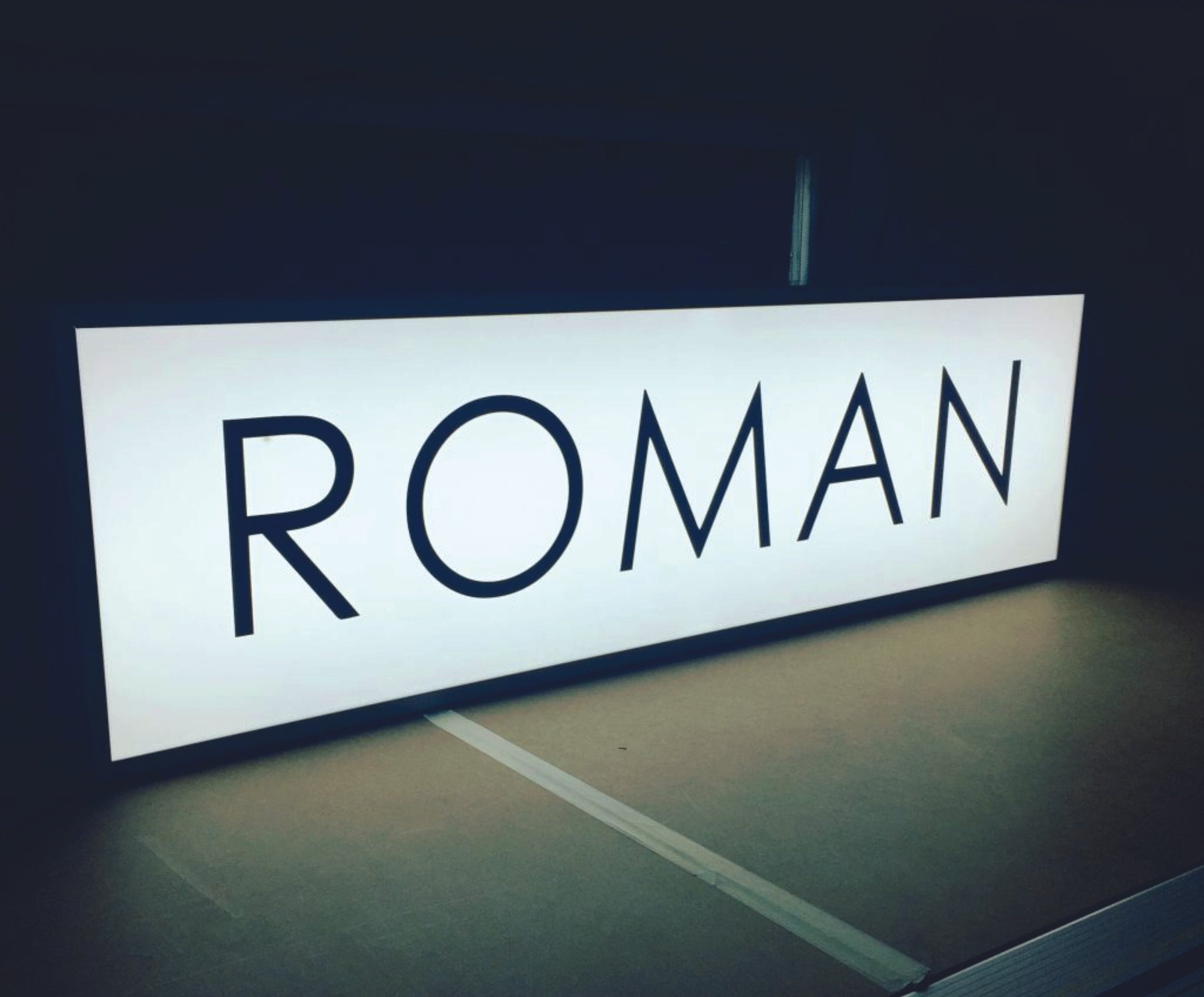 Illuminated sign with the word 'ROMAN'. Lightbox signage. Raised LED Letters. Illuminated signage. Signmakers Cork & Kerry, Ireland.