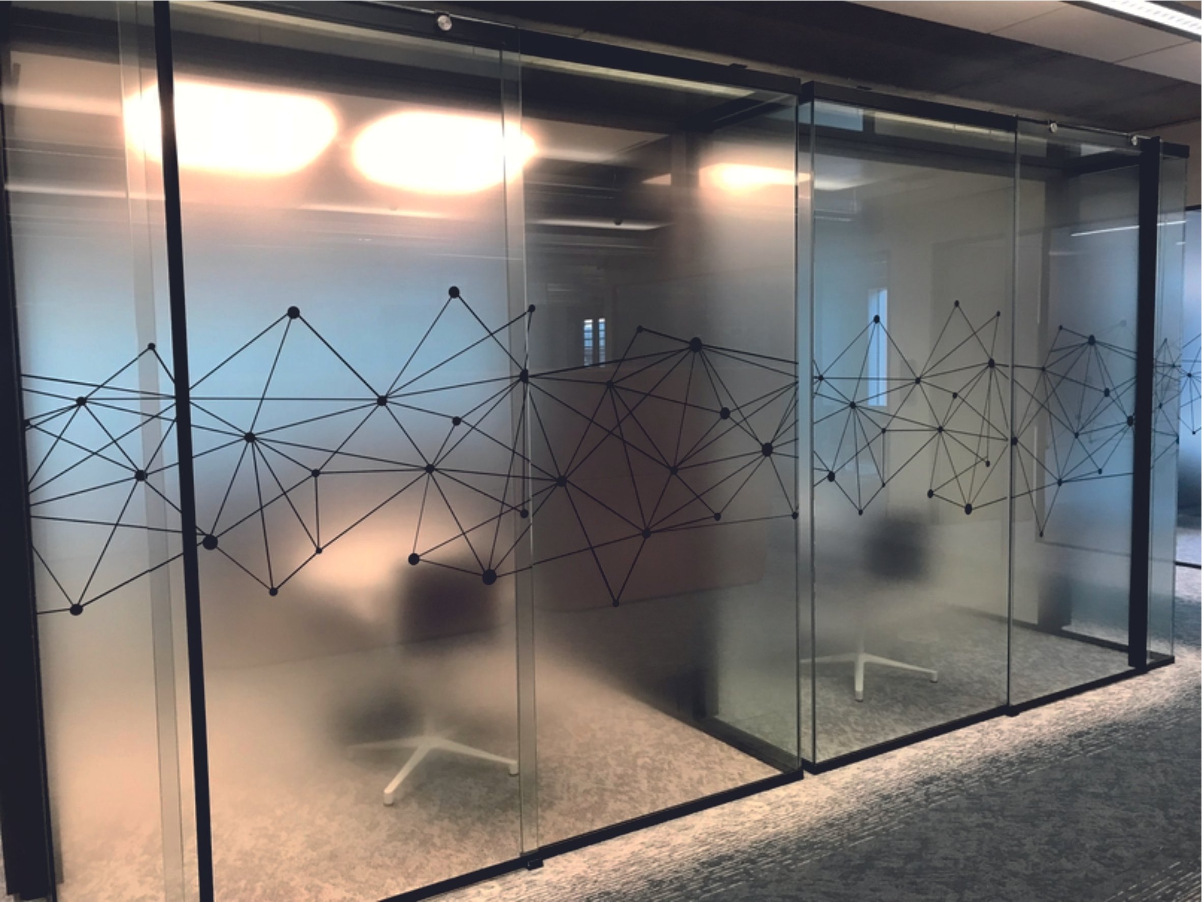 Office space with glass partitions featuring geometric patterns. Frosted Vinyl. Window Manifestations. Signmakers Cork & Kerry, Ireland.