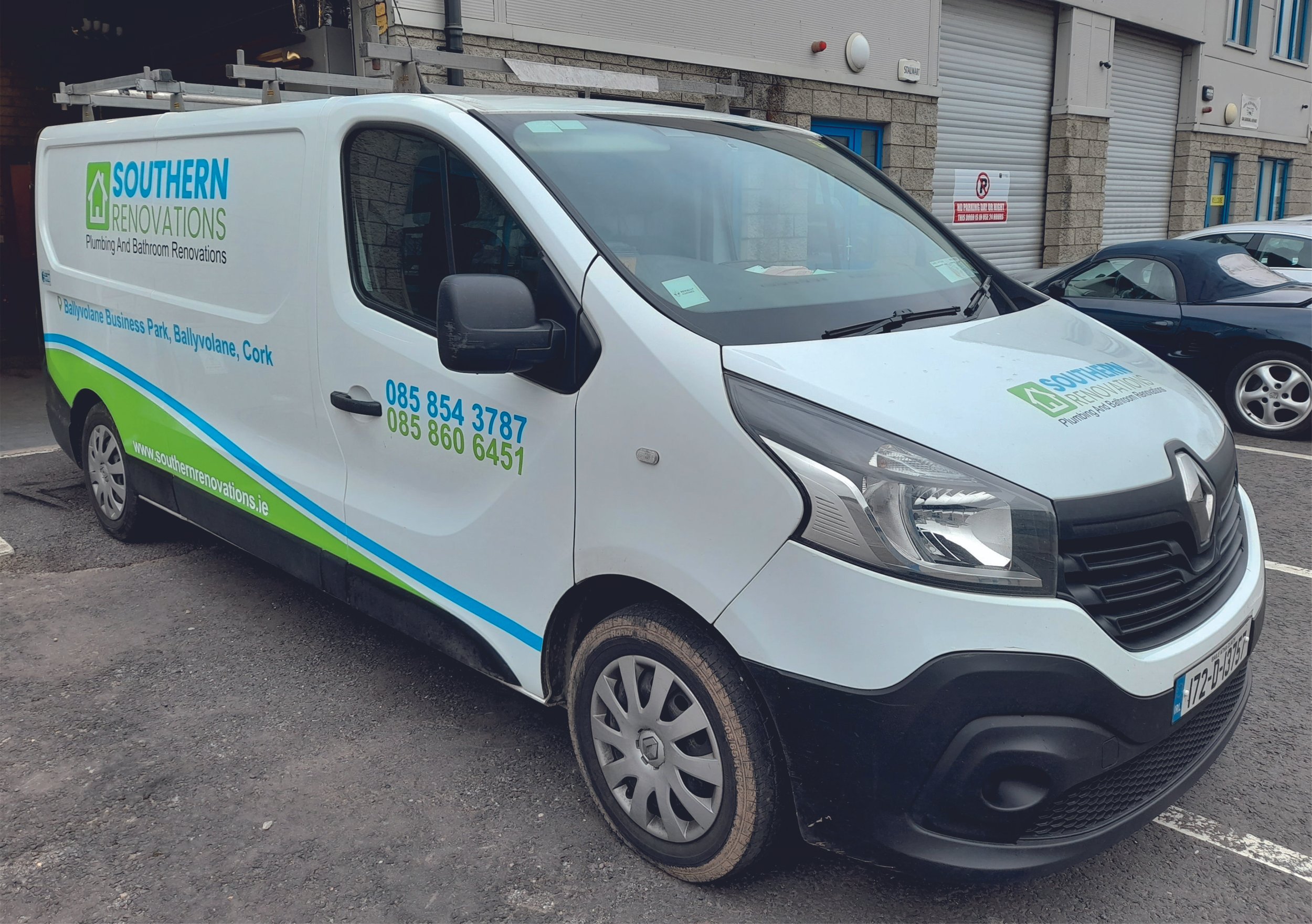 White Renault van with cut lettering logo and contact details, parked outside a building. Vehicle wrap. Vehicle Graphics. Commercial Vehicle Branding. Signmakers Cork & Kerry, Ireland.