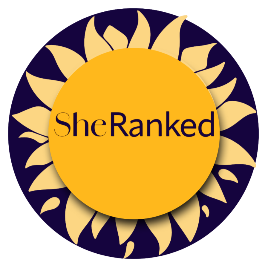 A circular logo with a dark purple background, surrounded by a cream-colored sunflower pattern, featuring a yellow center with the text "She Ranked" in black and purple letters.
