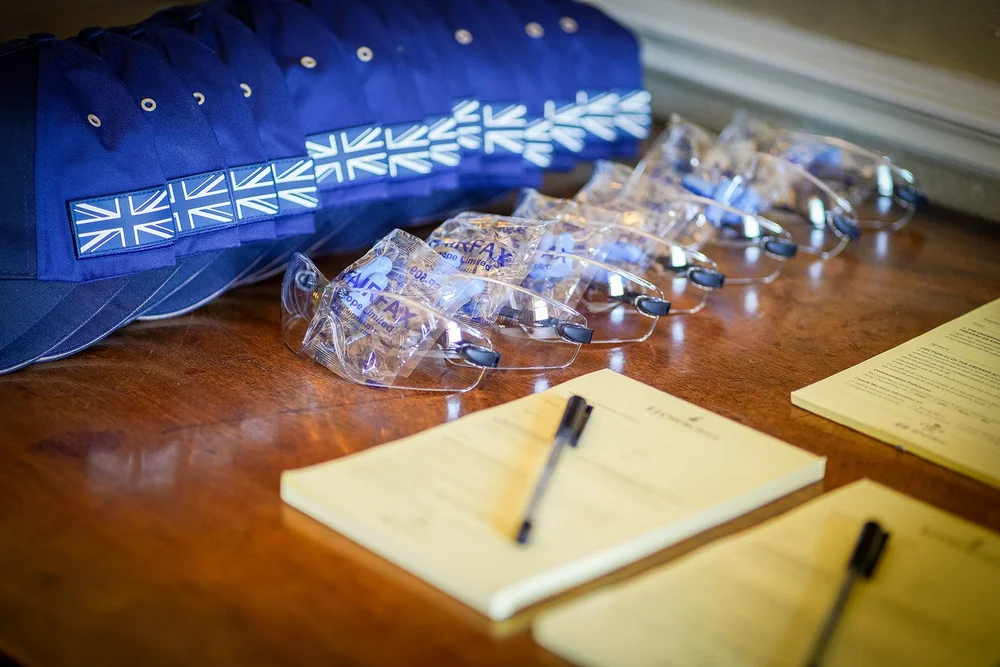 Event materials, glasses and stationery laid out for guests
