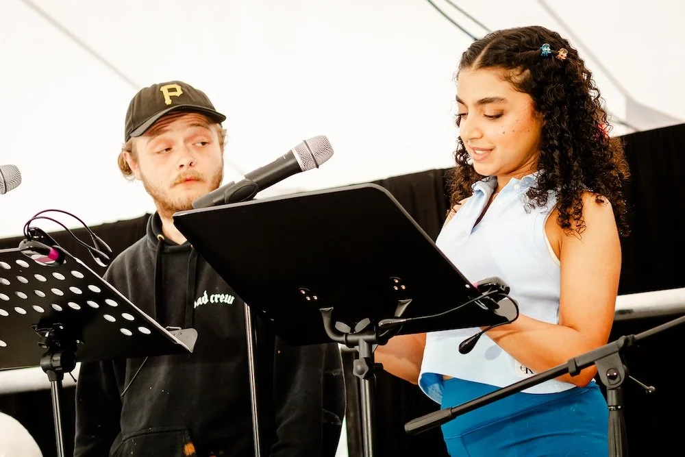 A script-in-hand performance at Fresh Ink 2026. Photo by Studio Blue Creative.