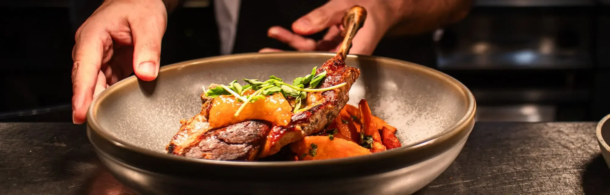 Chef prepares The Engine Rooms signature pork tomahawk