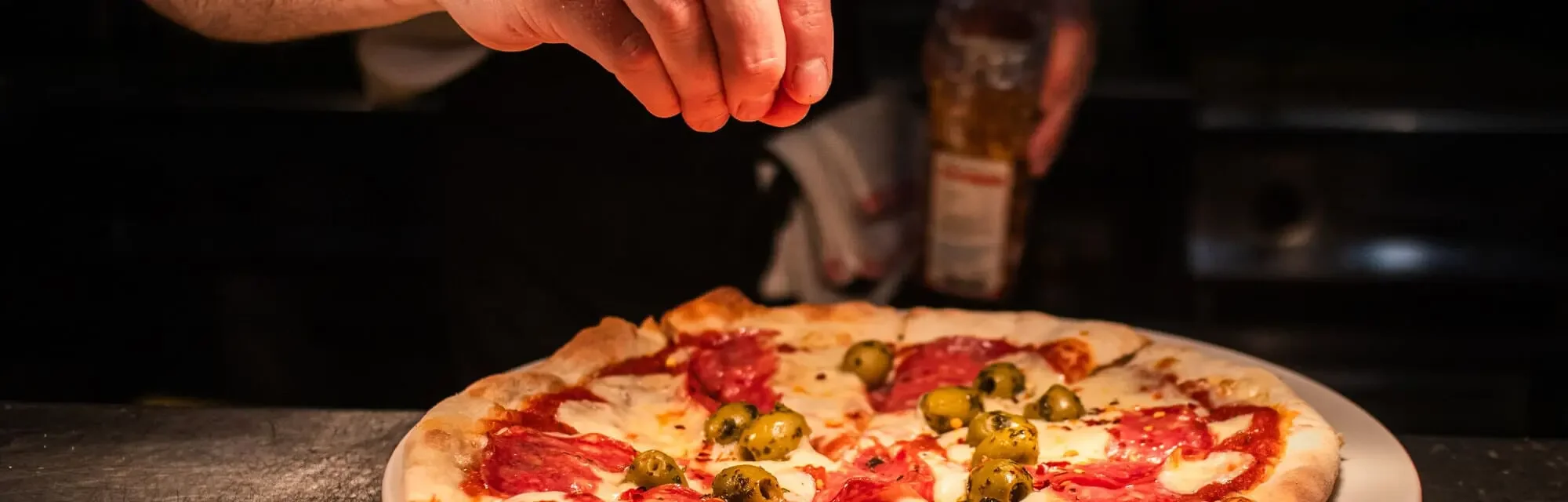 Diavola pizza gets the final touches