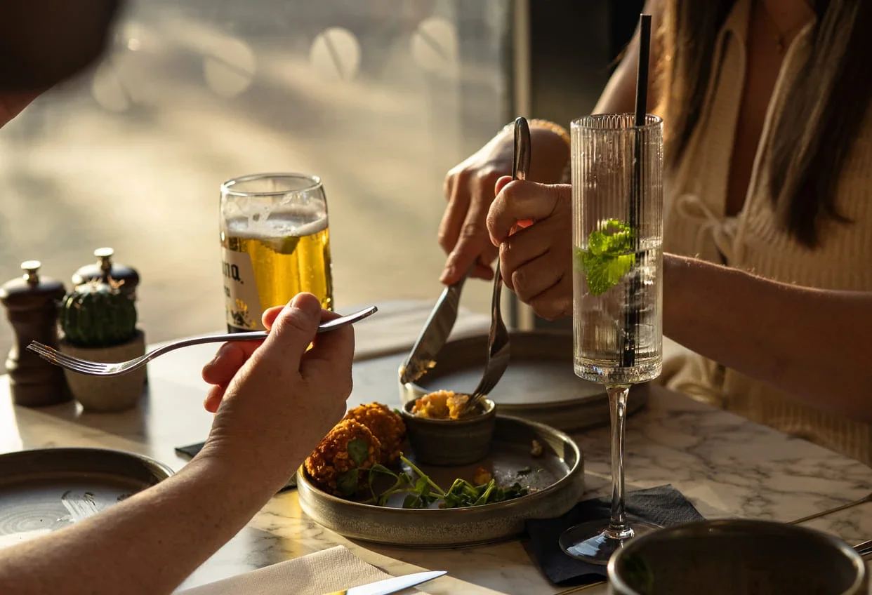 Close up shot of a table set with appetisers, prosecco and beer at The Engine Room in Derby