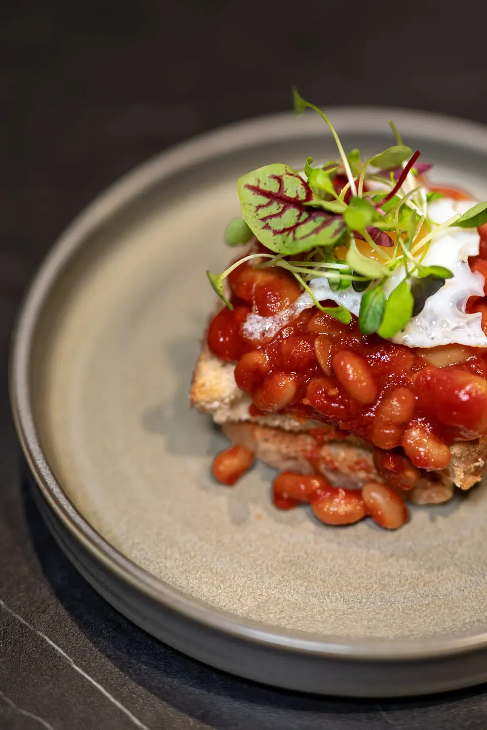 Our 'beans on toast' - homemade beans, Welsh rarebit, focaccia, fried quail egg, Hendersons relish