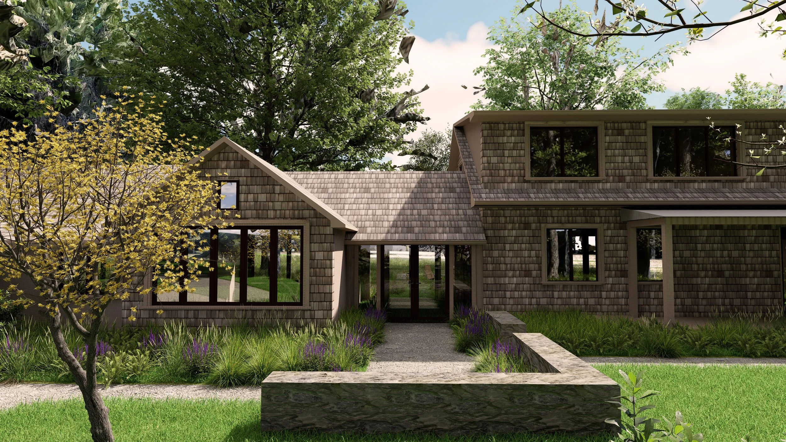 Entry facade with low stone wall and spring planting