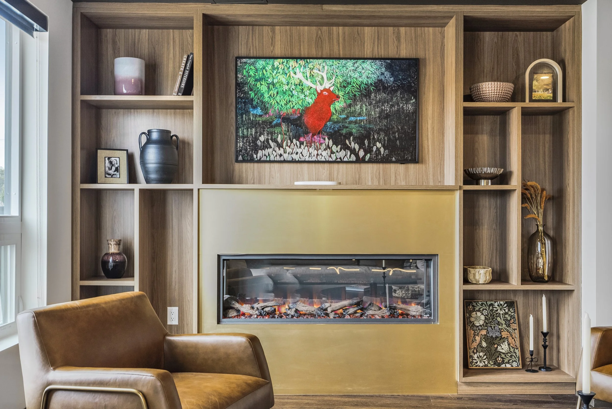 Modern recreation room with a pool table, a dining area, and a black accent wall with shelves, large windows and a balcony door, and wood flooring.