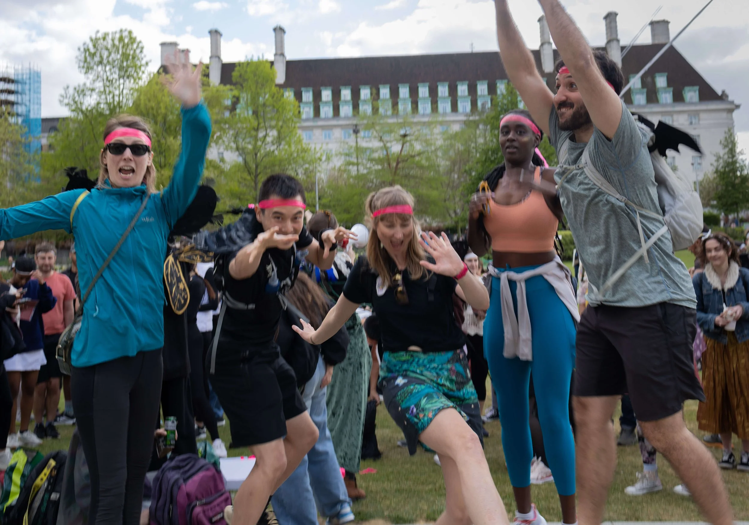 Group of participants celebrating during an outdoor community festival in London.