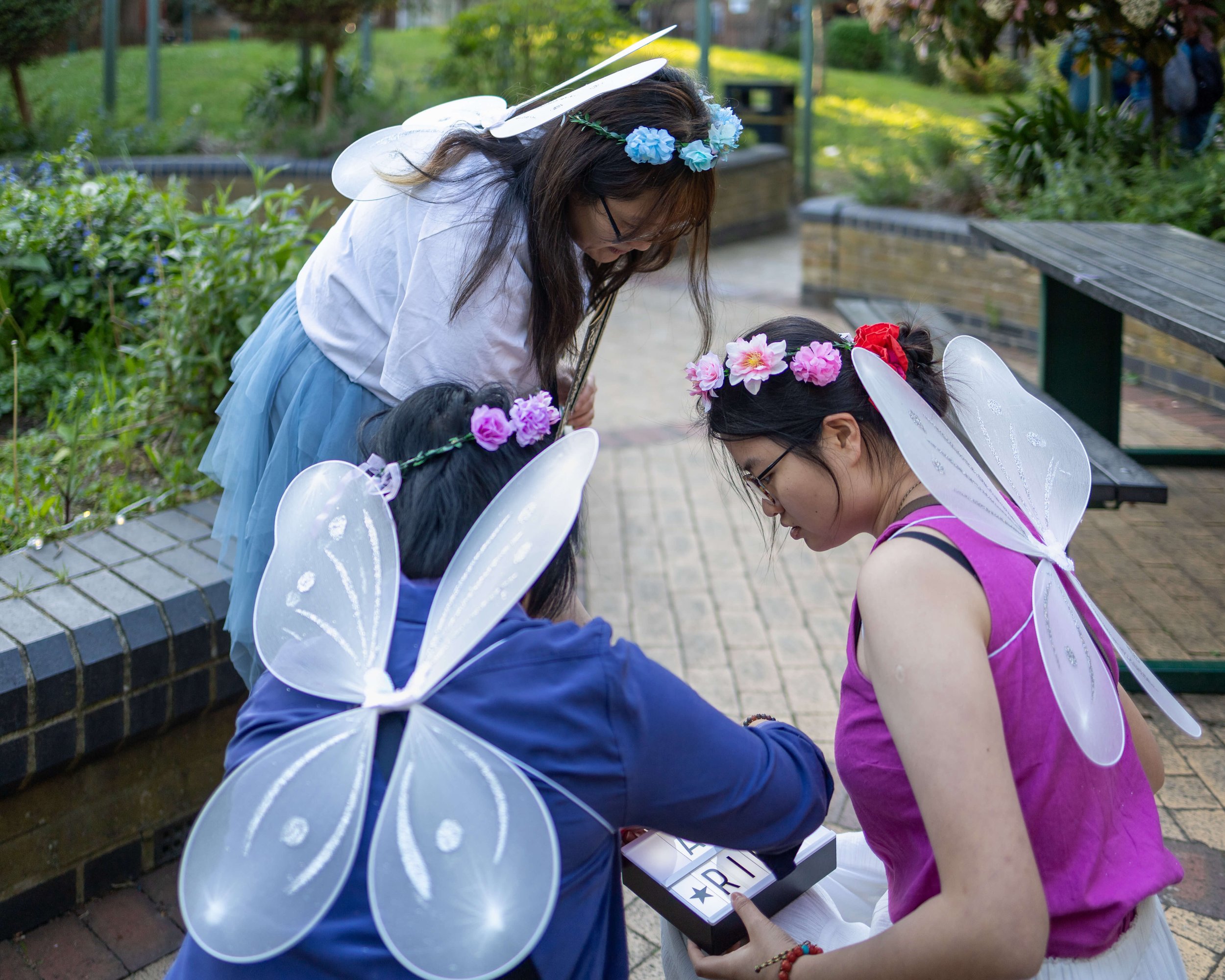 Checkpoint agents dressed in colourful fairy costumes during an urban outdoor game in London.