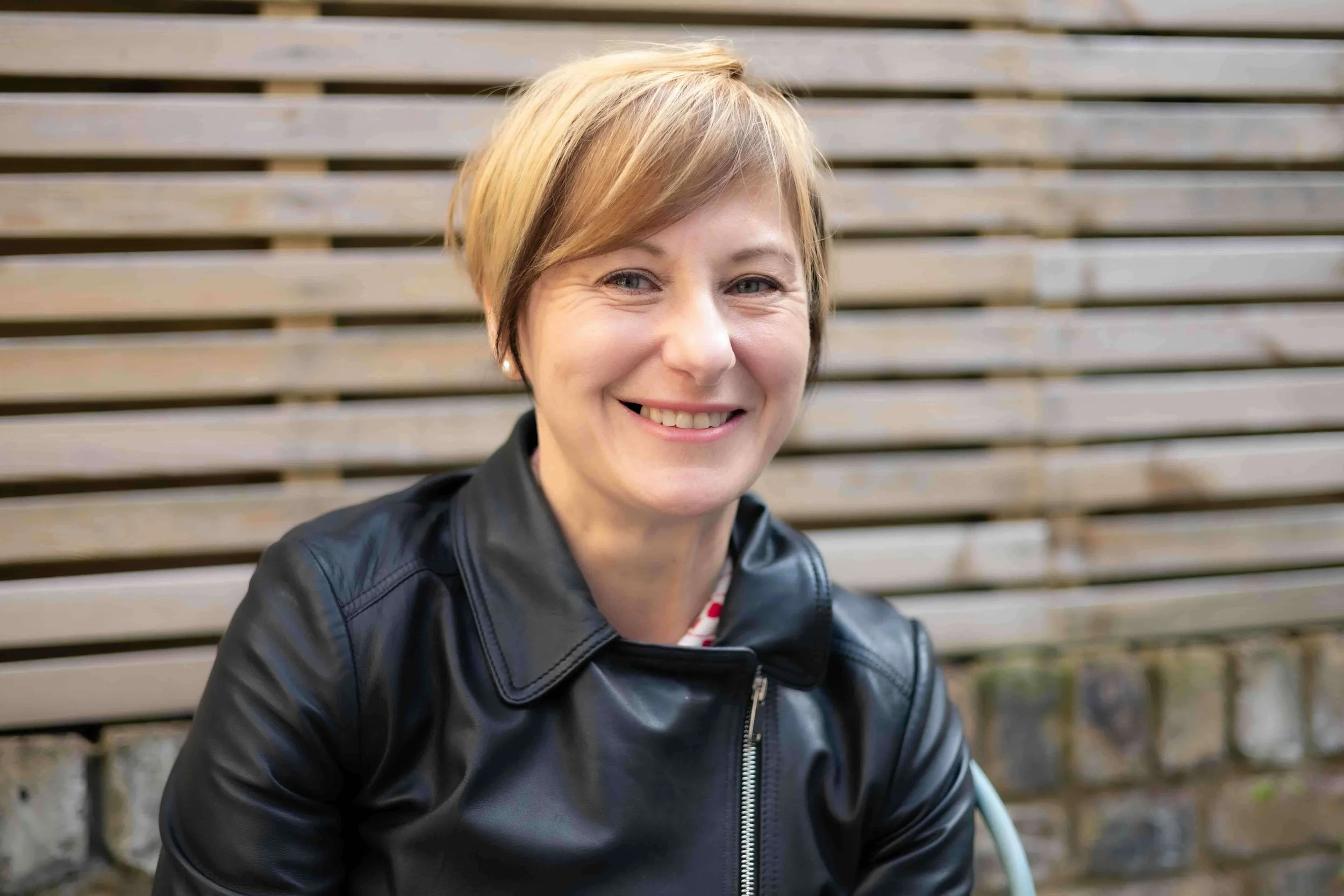 London event photographer Kasia Wawrzon-Stewart smiling outdoors