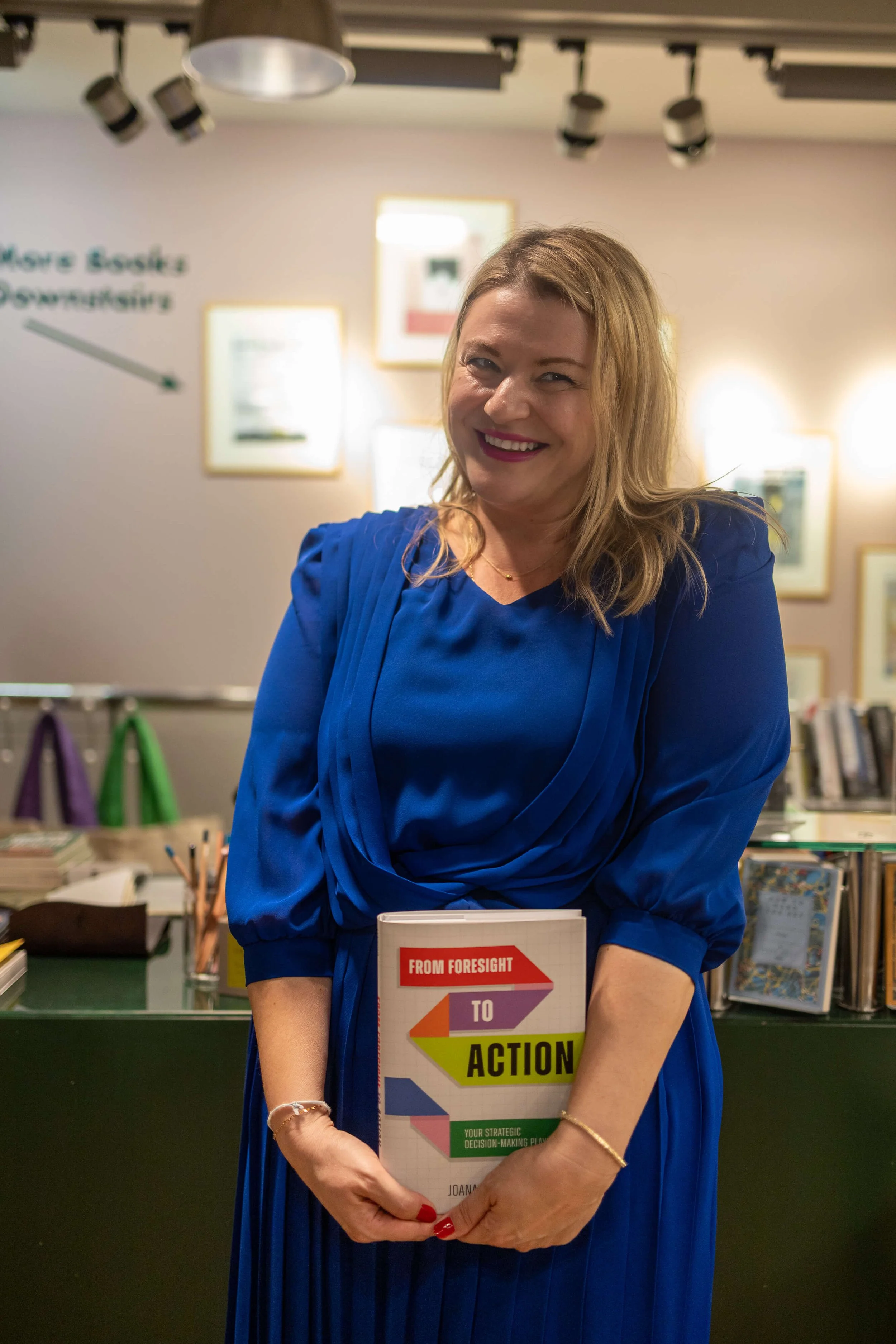 Author Joana Lenkova smiling and posing with her book at the London Review of Books