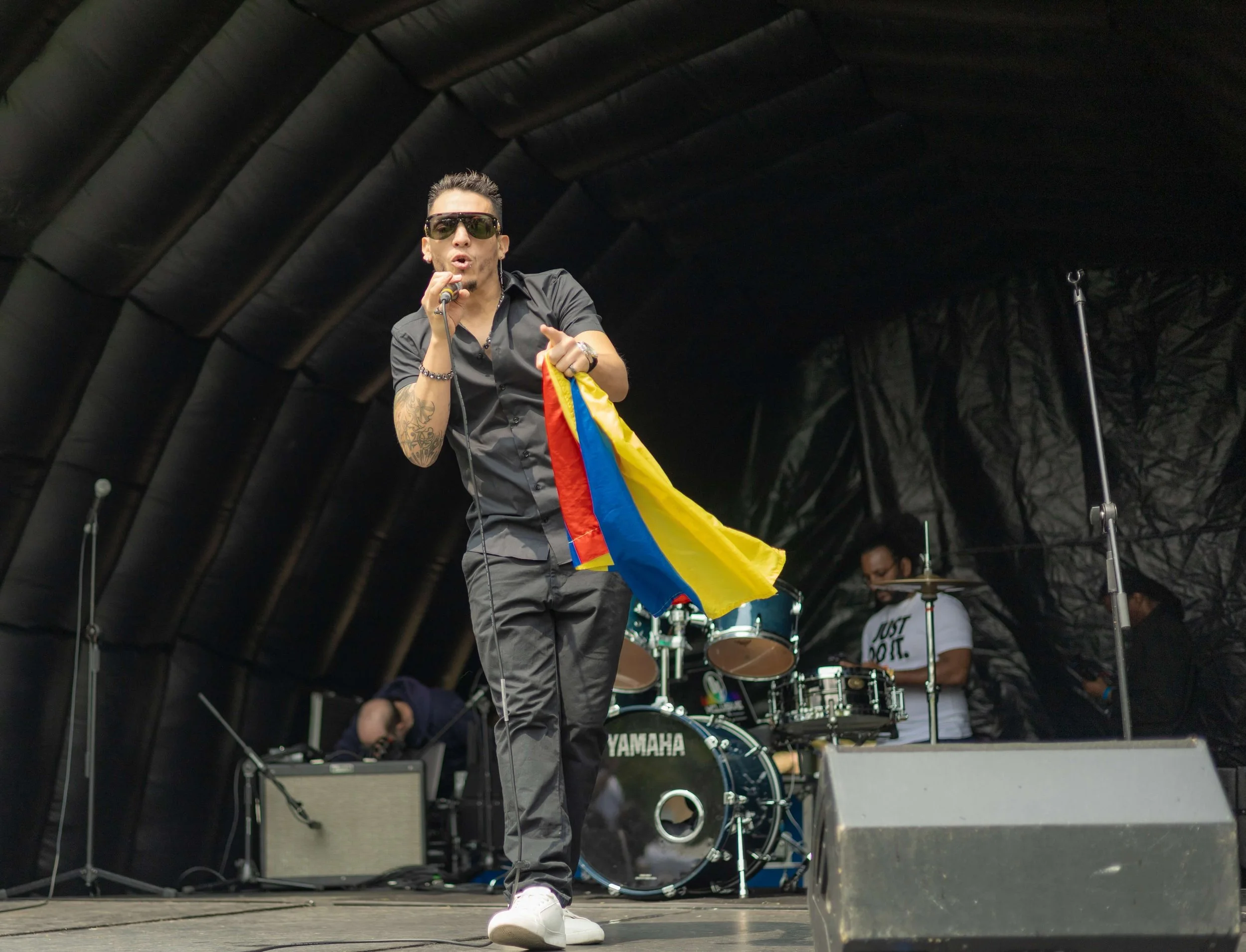 Live musician performing on stage during Max in the Park in Lewisham.