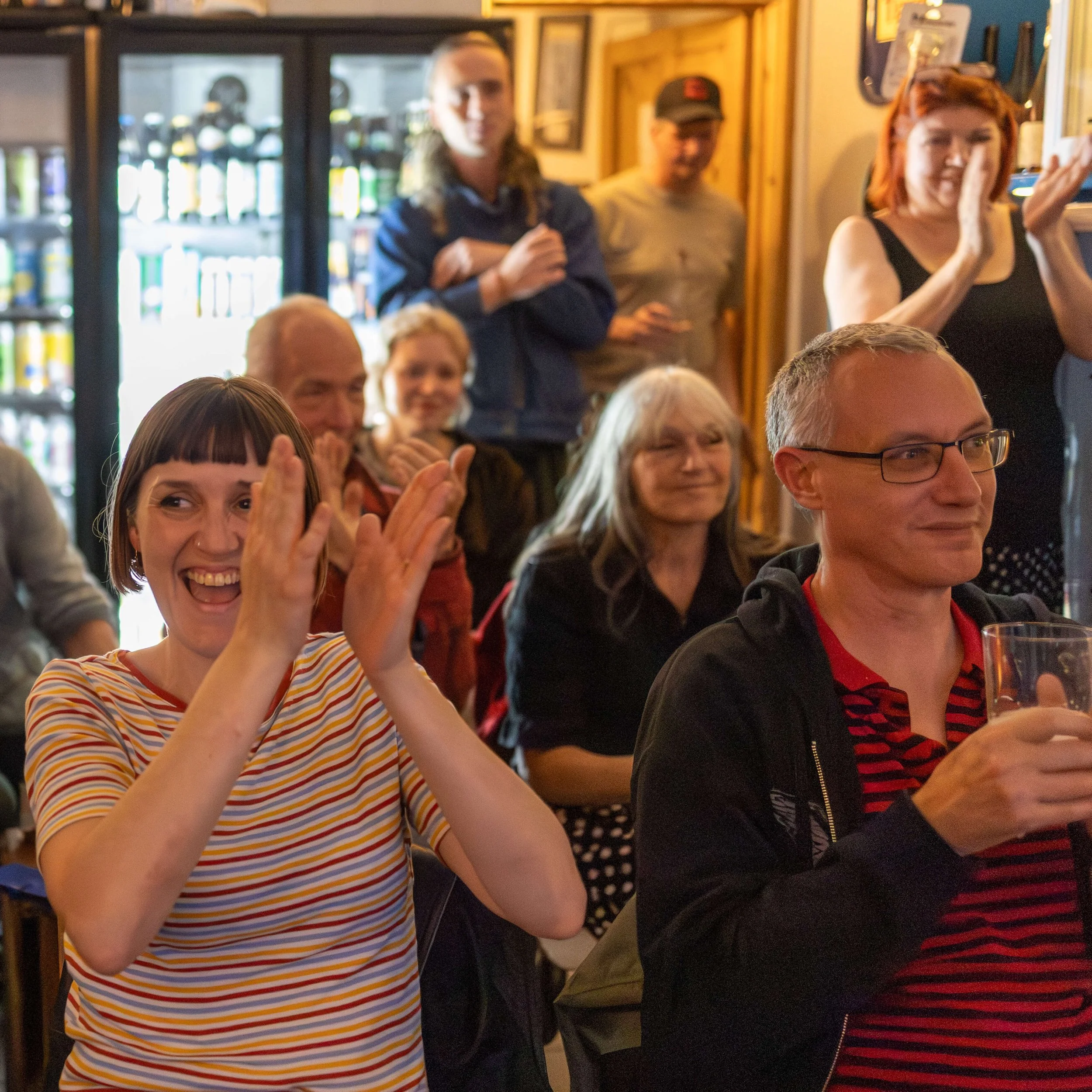 Audience applauding during a live community event in London.