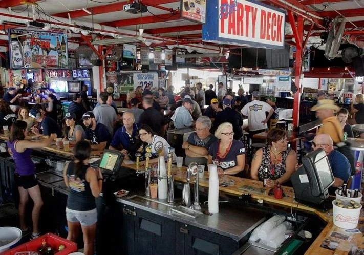 Crowded interior of Ferg’s Sports Bar in downtown St. Pete with fans watching games, drinking, and enjoying the lively atmosphere.