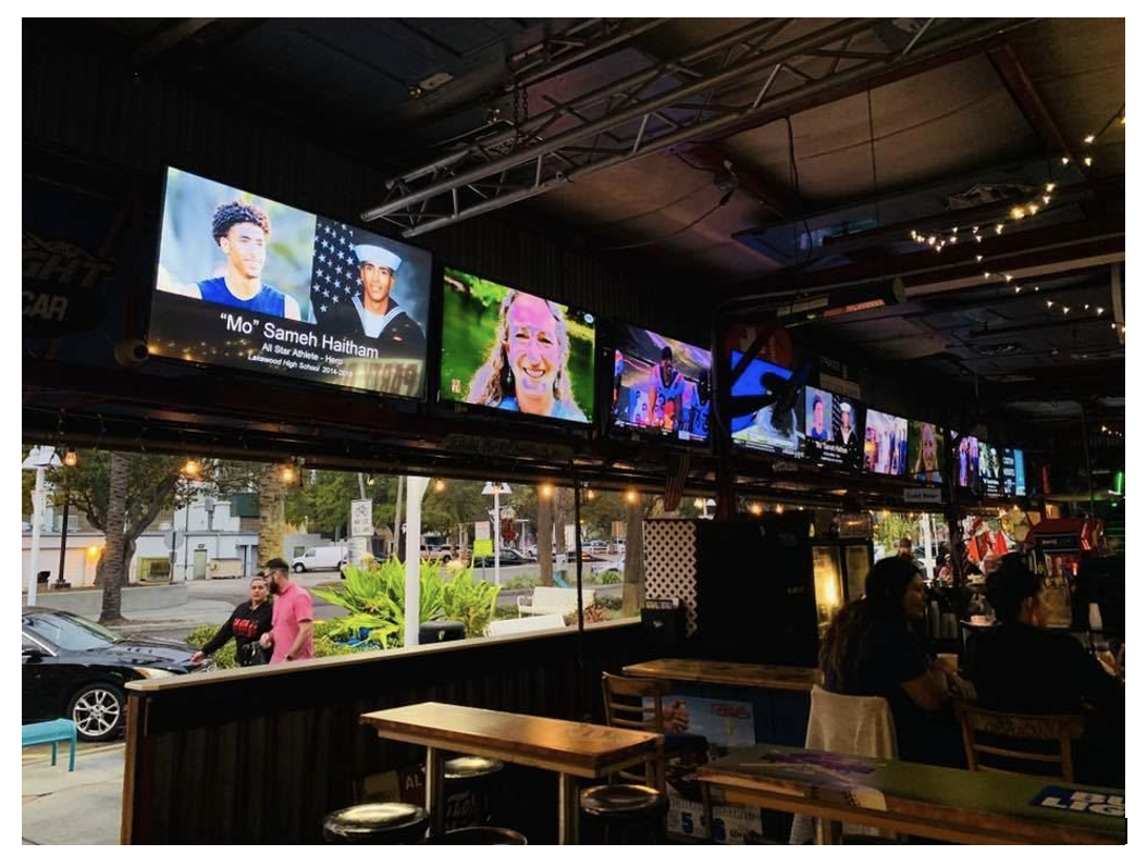 Interior of Ferg’s Sports Bar in downtown St. Petersburg, Florida with TVs and bar seating during March Madness