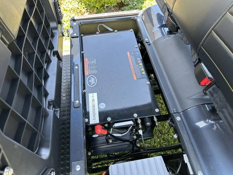 View of the safe enclosed battery bay under the front seat.