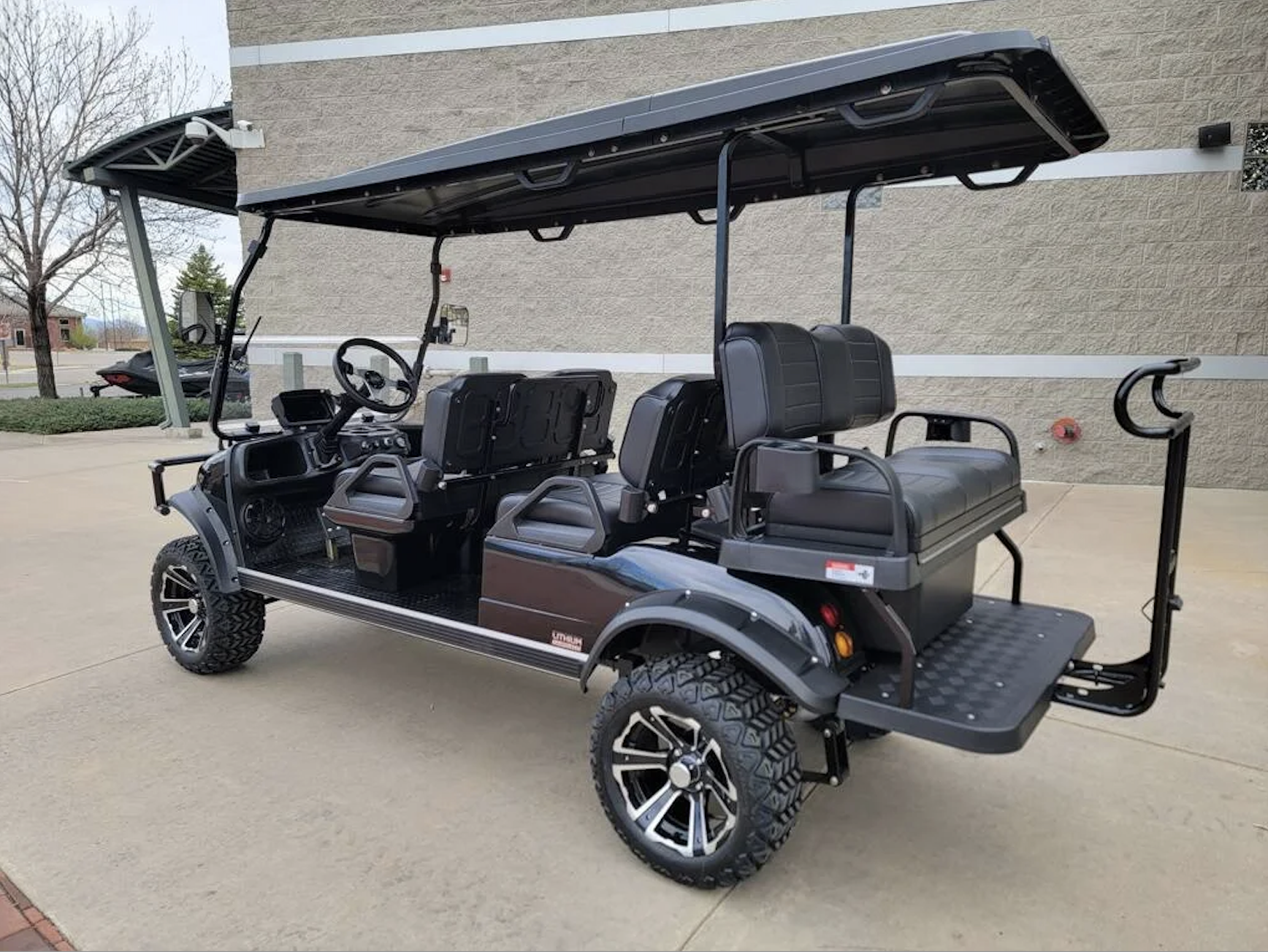 Rear angle highlighting seating layout and cargo deck.