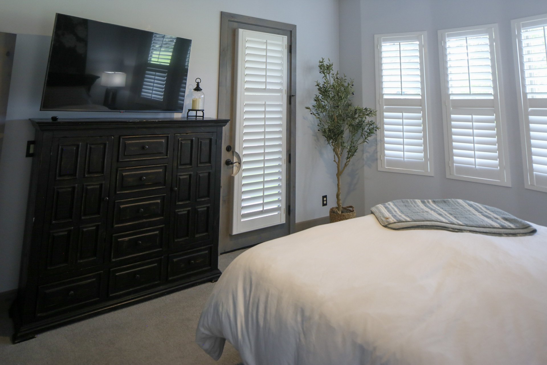 The Clubhouse Suite features direct access to the back patio, large dresser, Smart TV, and plenty of natural light